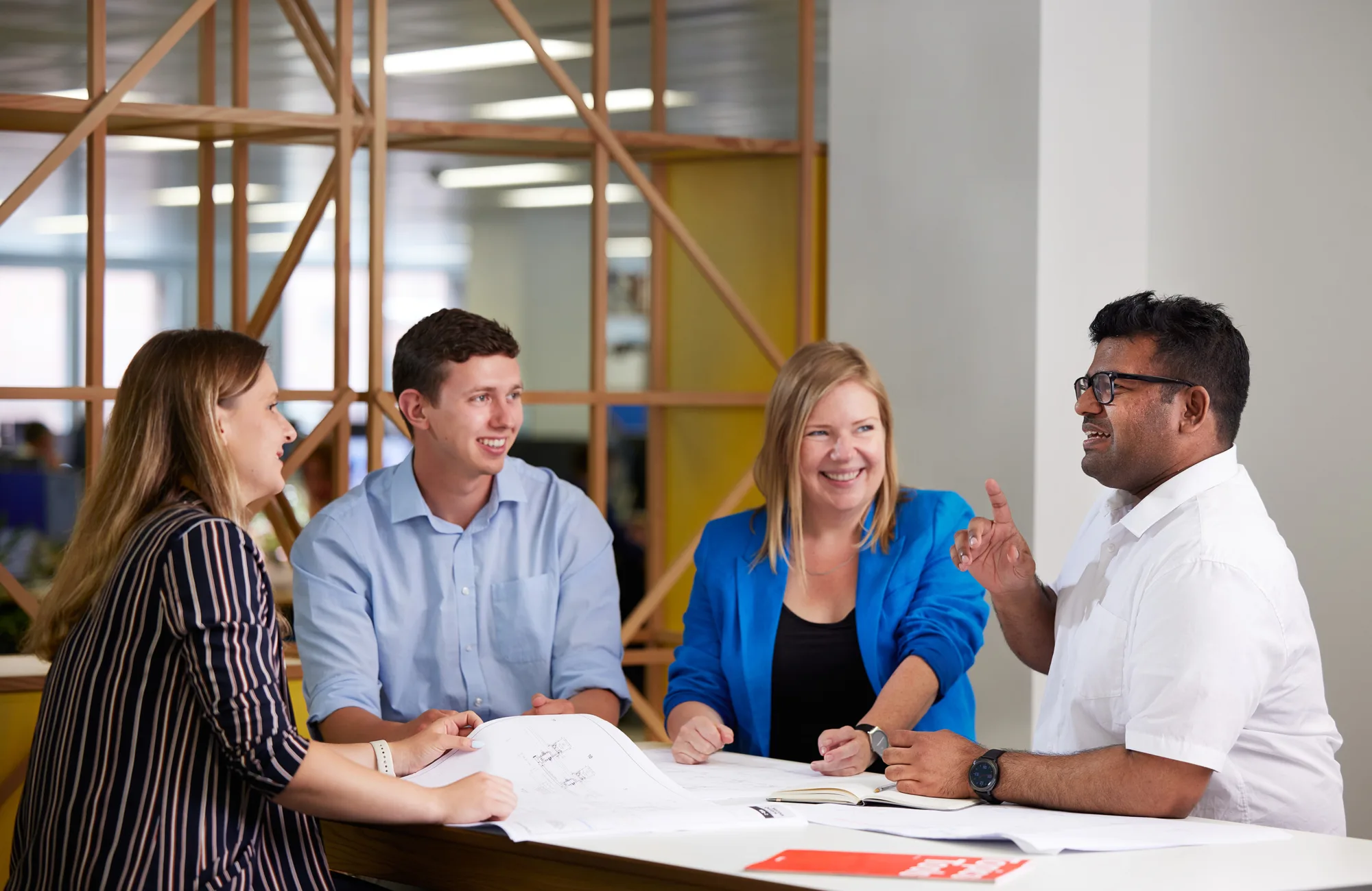 Cundall employees around desk discussing work