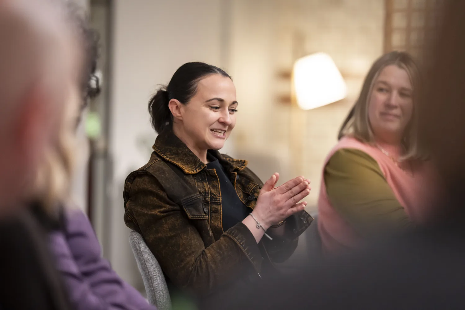 People sat around a table in conversation
