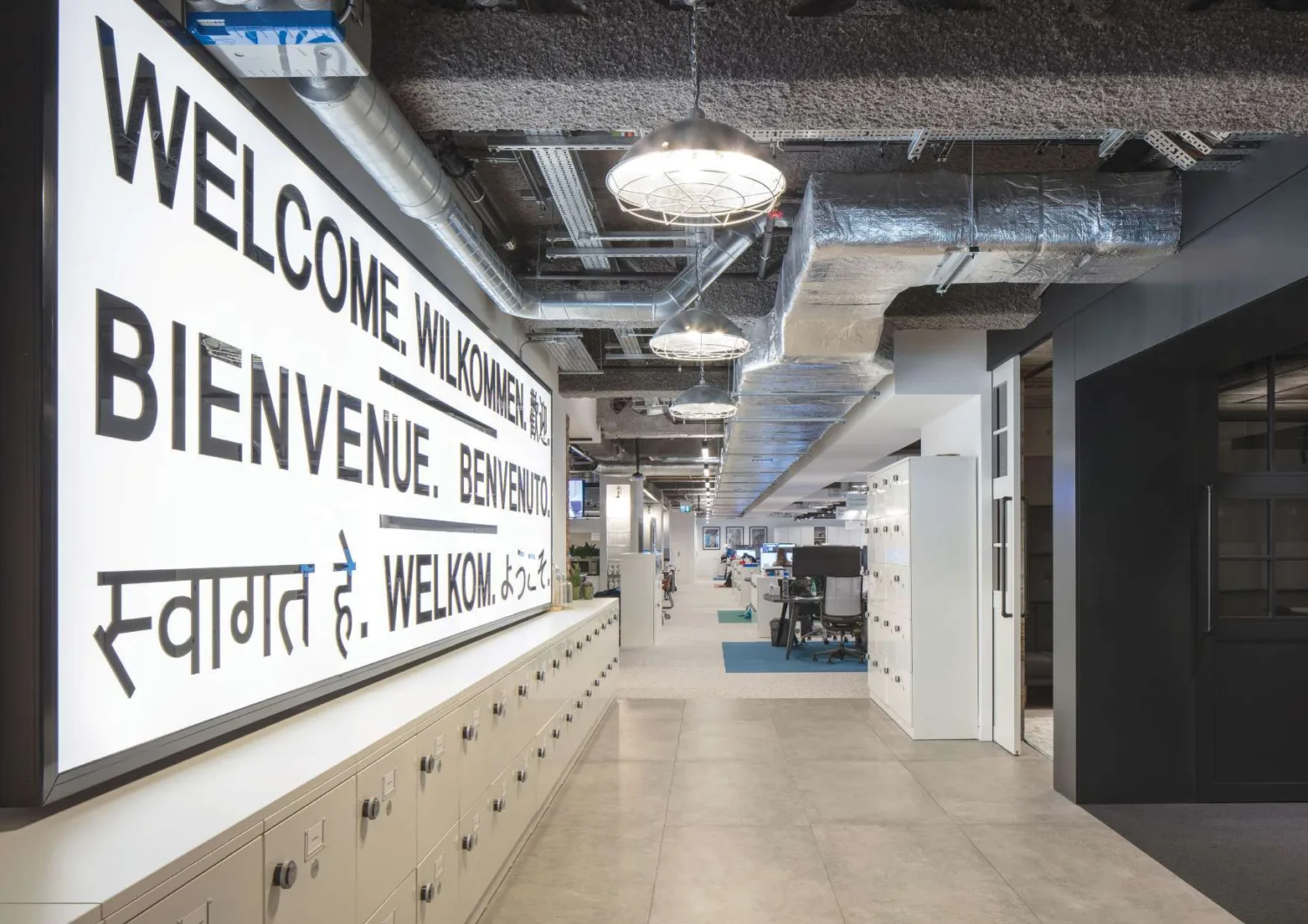 An industrial style office with grey SonaSpray on the ceiling