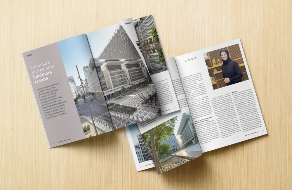 An open magazine on a wood surface showing an article entitled "Landmark partnership, landmark results", the opposite page features a photo of Bysshe Wallace.