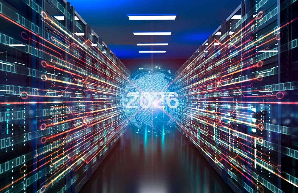 Futuristic data centre hallway with rows of server racks lit by blue and red lights; digital circuit lines converge towards a glowing globe showing “2026” at the centre.