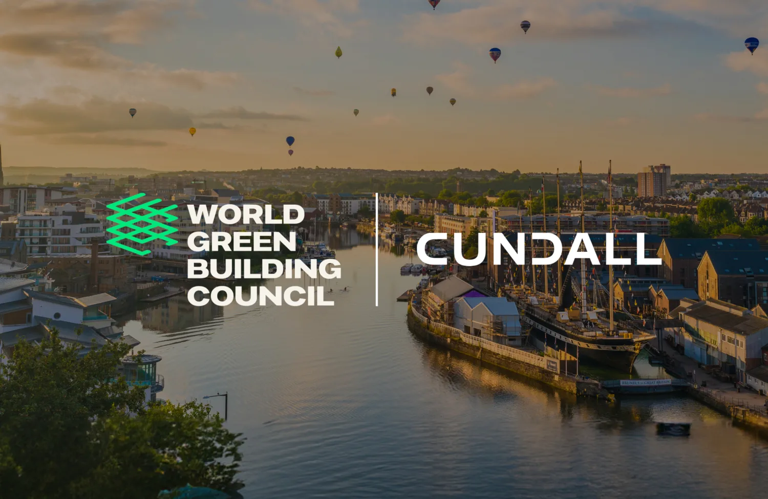 Cityscape with a river, buildings, and greenery. Hot air balloons float in the sky. Centre text reads 'WORLD GREEN BUILDING COUNCIL' and 'CUNDALL'.
