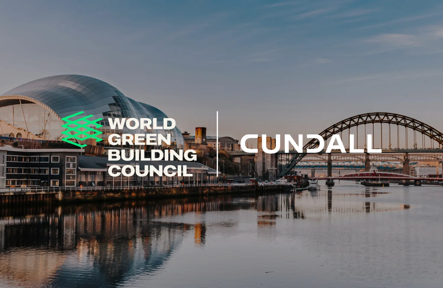 Cityscape with a modern curved glass building on the left and a large arched bridge over a river. Centre text reads 'WORLD GREEN BUILDING COUNCIL' and 'CUNDALL'.