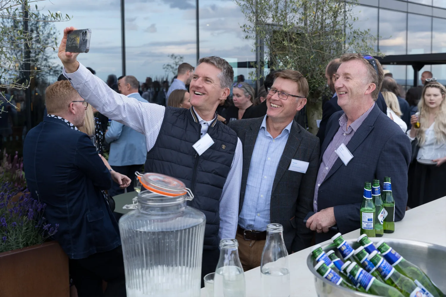 Three people stood next to the outdoor bar taking a selfie