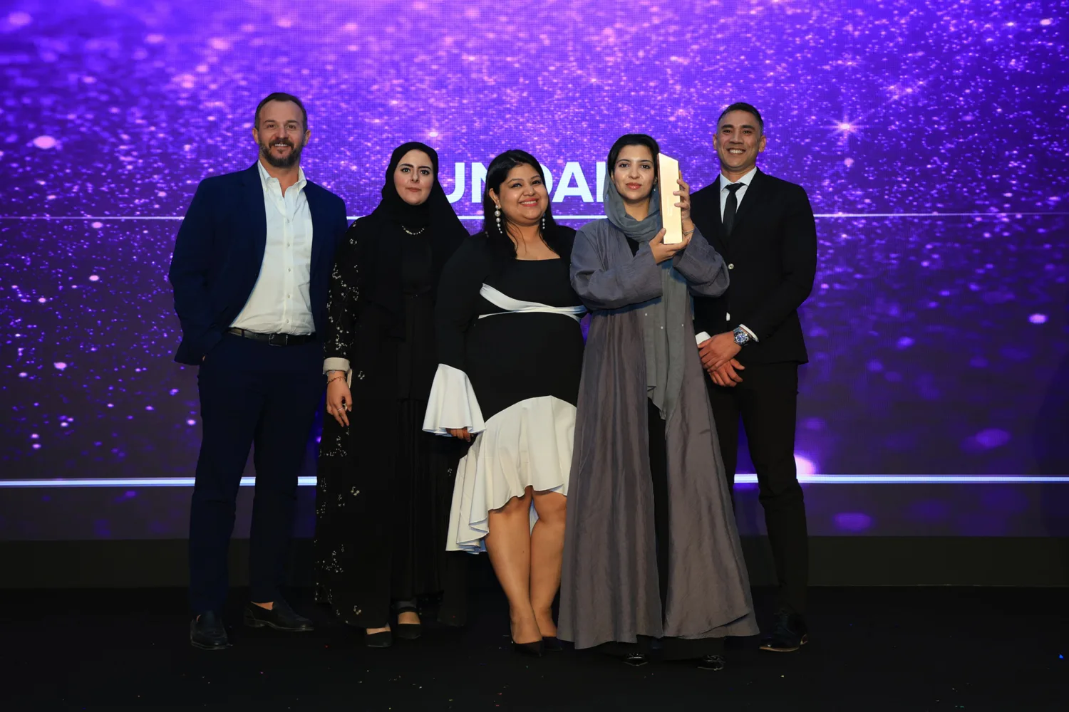 Cundall employees holding the Consultancy of the Year trophy at the CW KSA Awards 2025 during the award ceremony.