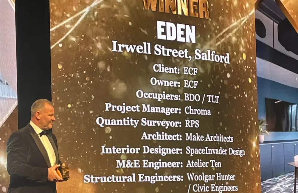 BCO National Awards 2025 stage with presenter and screen information on the project