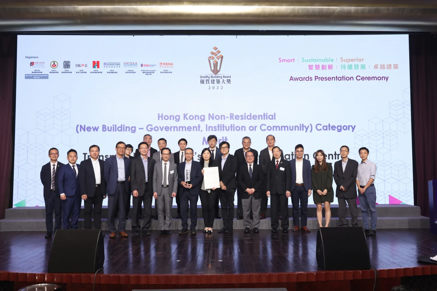 Award winning delegates standing on stage with certificate