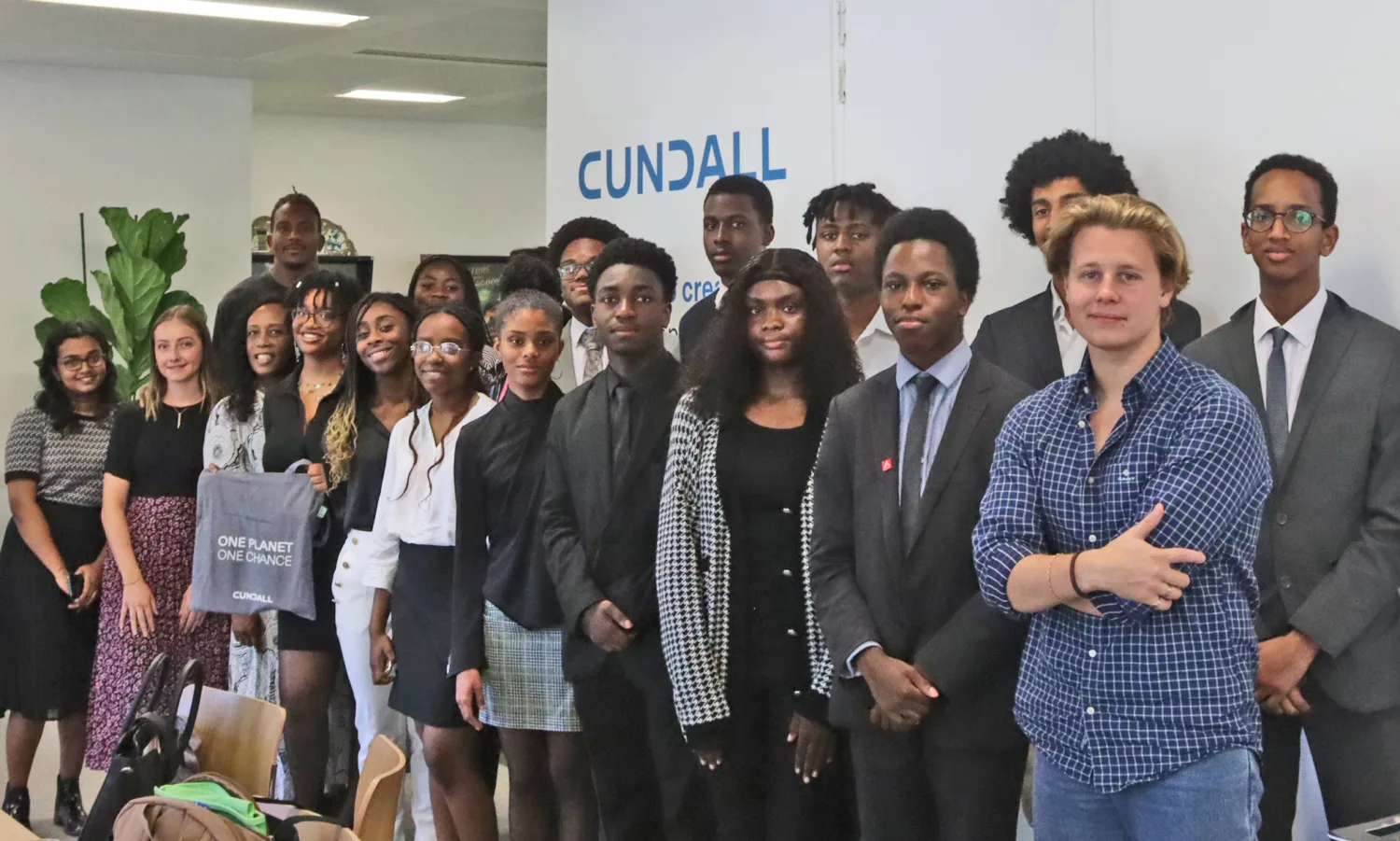 All the students stood in a group with Jack at the foreground