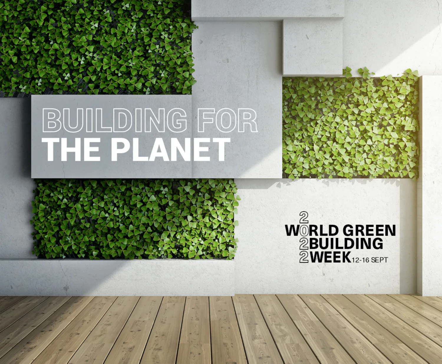 Wooden floor and a concrete and plant wall with the World Green Building Week logo.