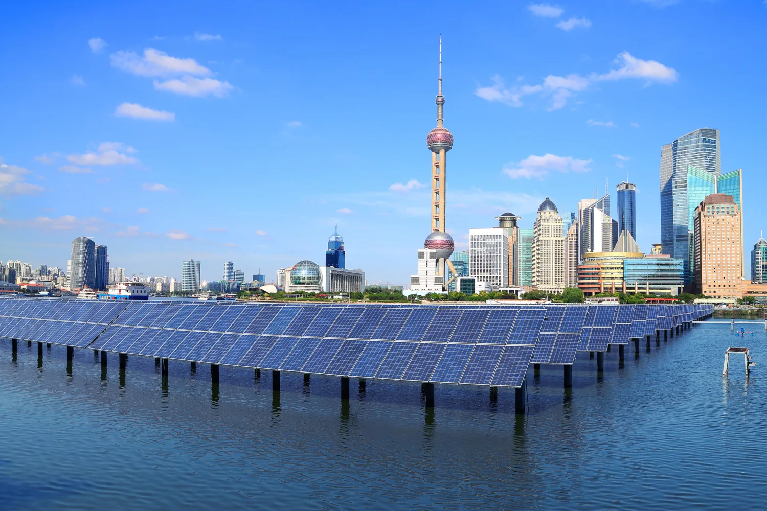 Shanghai building skyline with river in front with photovoltaics in the water