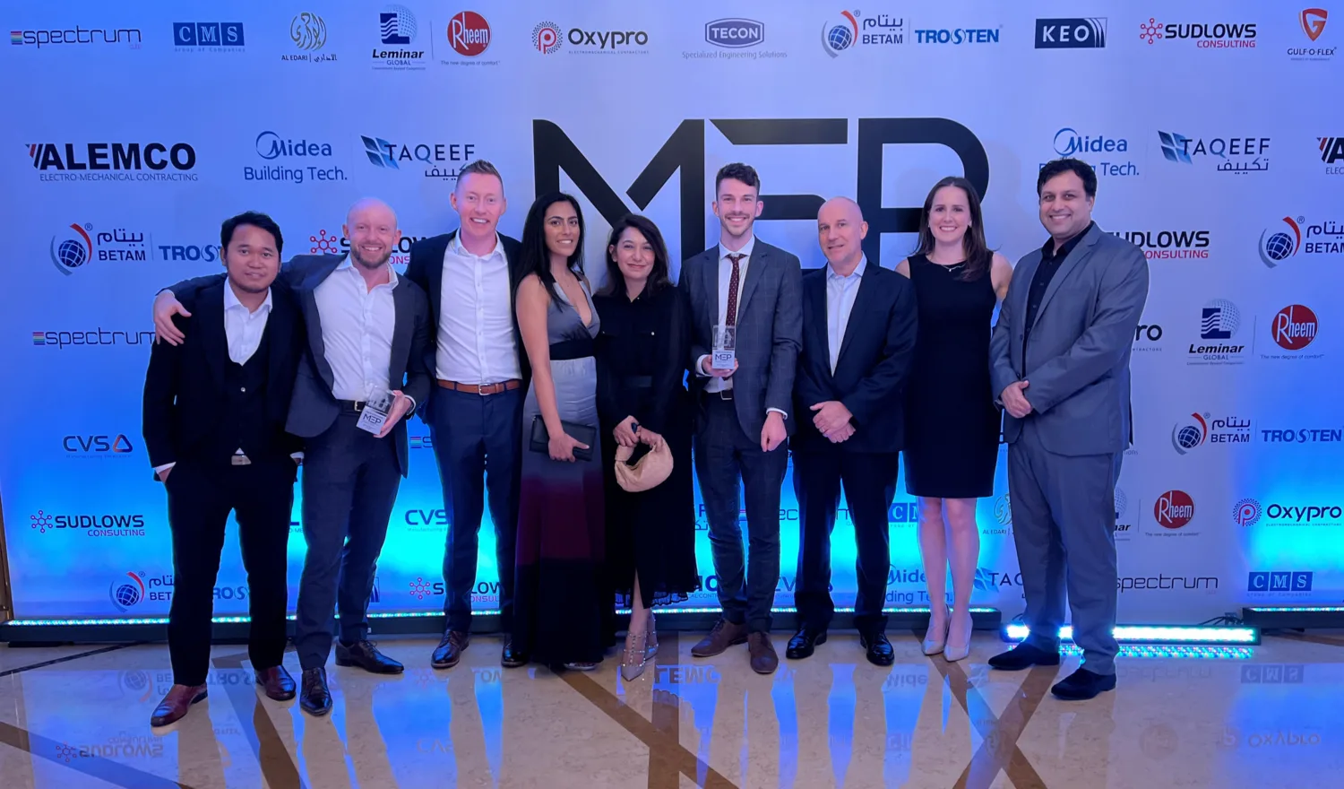 The Cundall Dubai MEP team posing for a photoshoot in a construction and engineering event in the region.