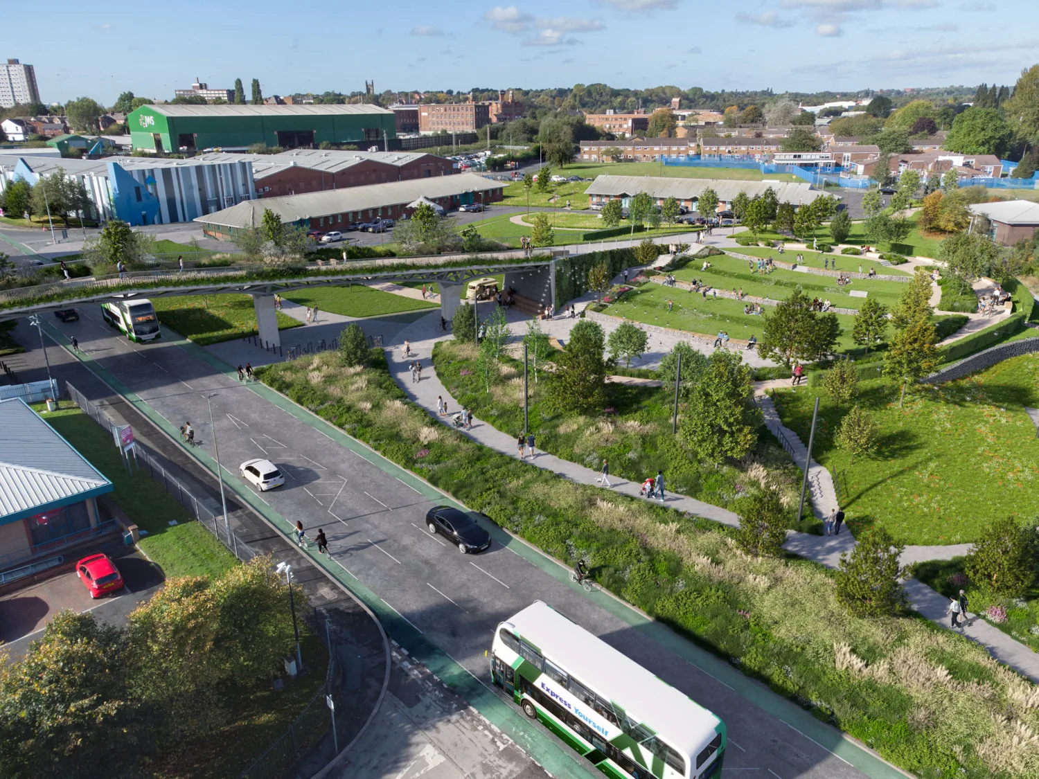 Aerial view of a road with walk ways in surrounding green space and a sky bridge
