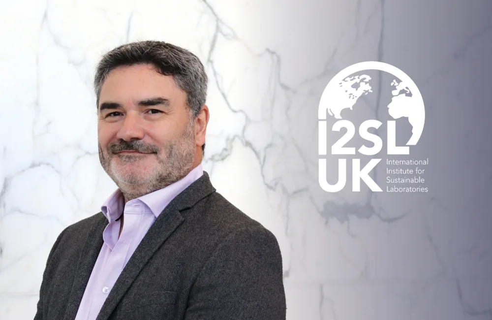 Head and sholders shot of Andrew Somerville against a marble background with the I2SLUK logo on right hand side.