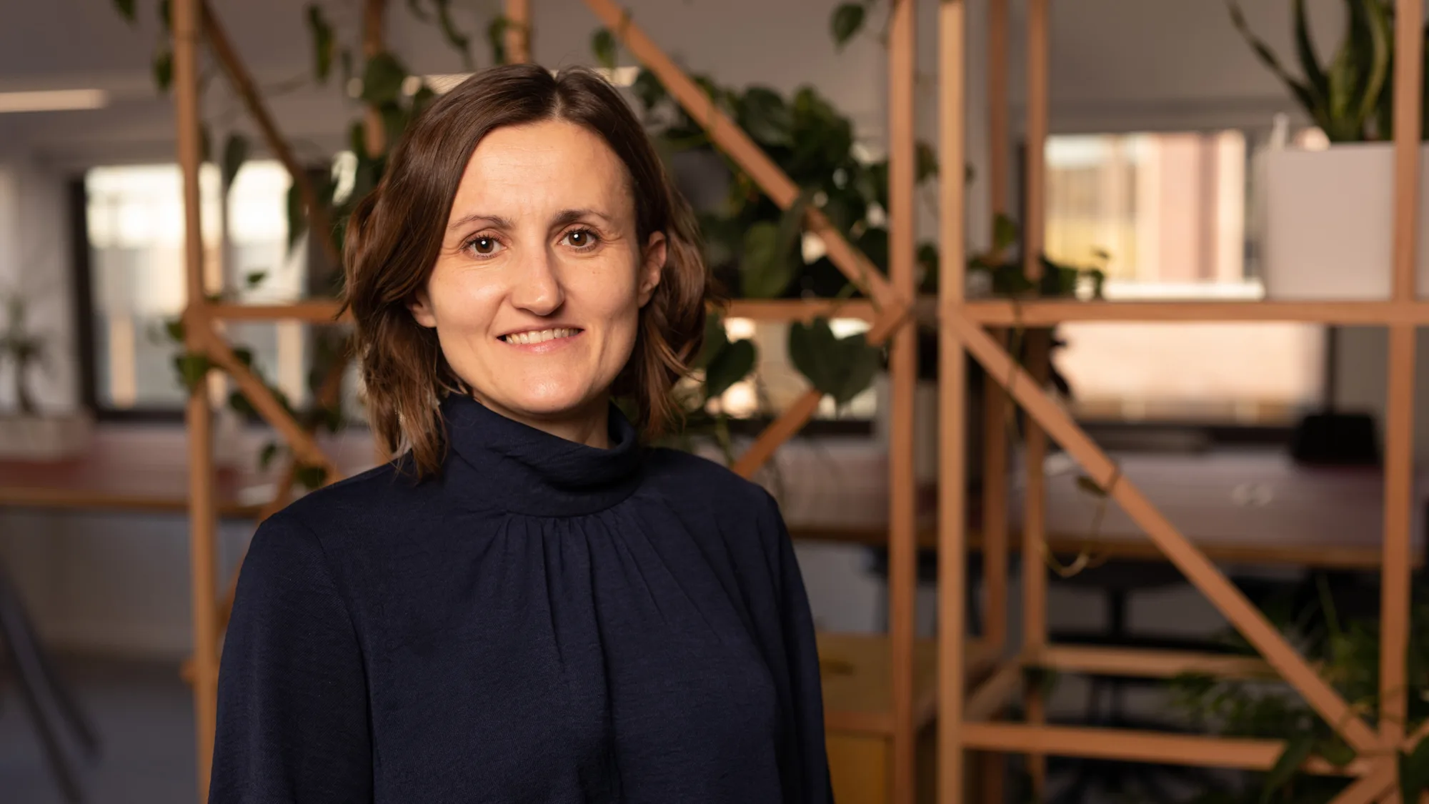 Barbara Smitten smiling looking towards the camera in a black top