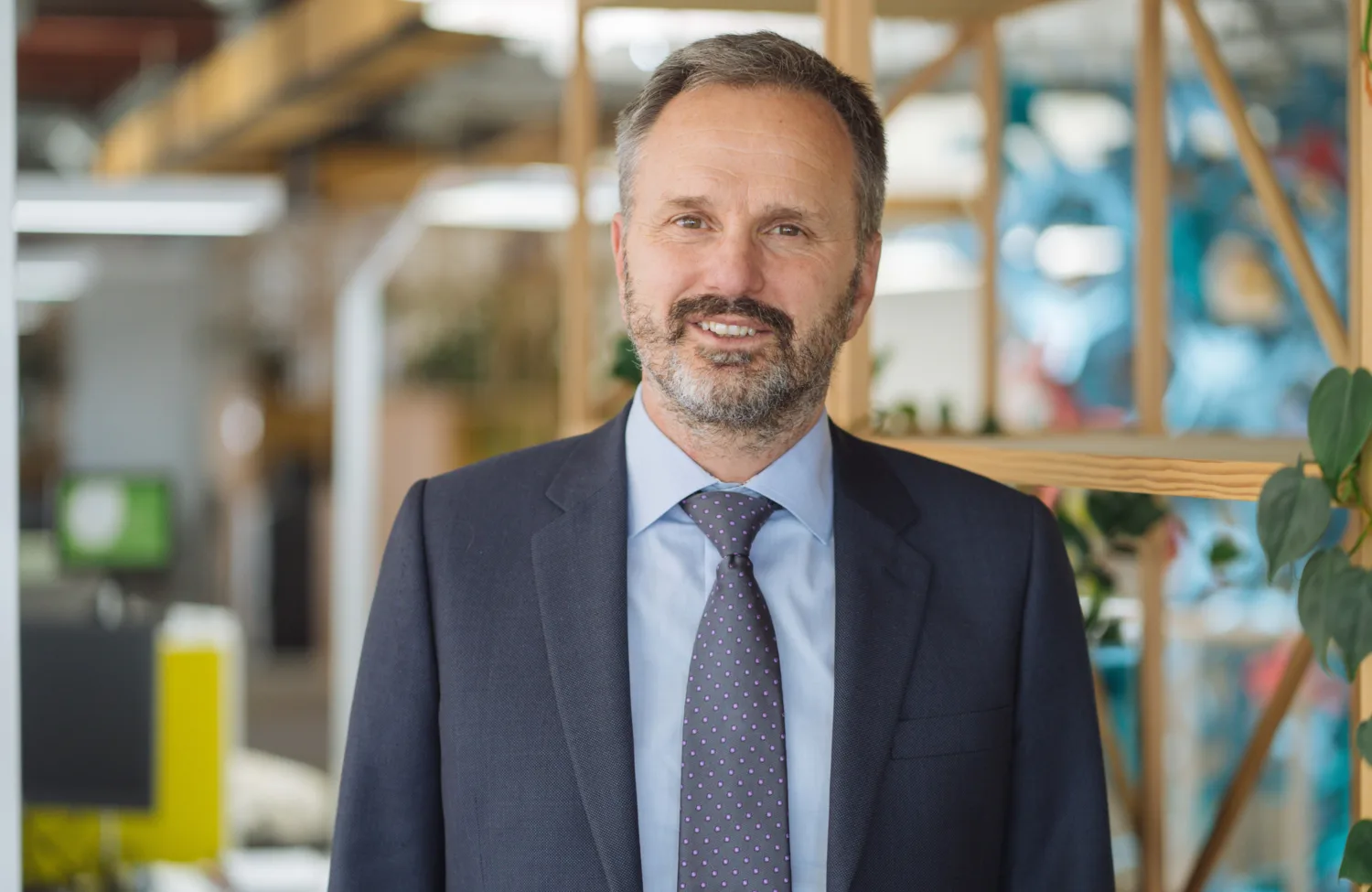 Rob van Zyl in a dark suit and tie with office blurred background