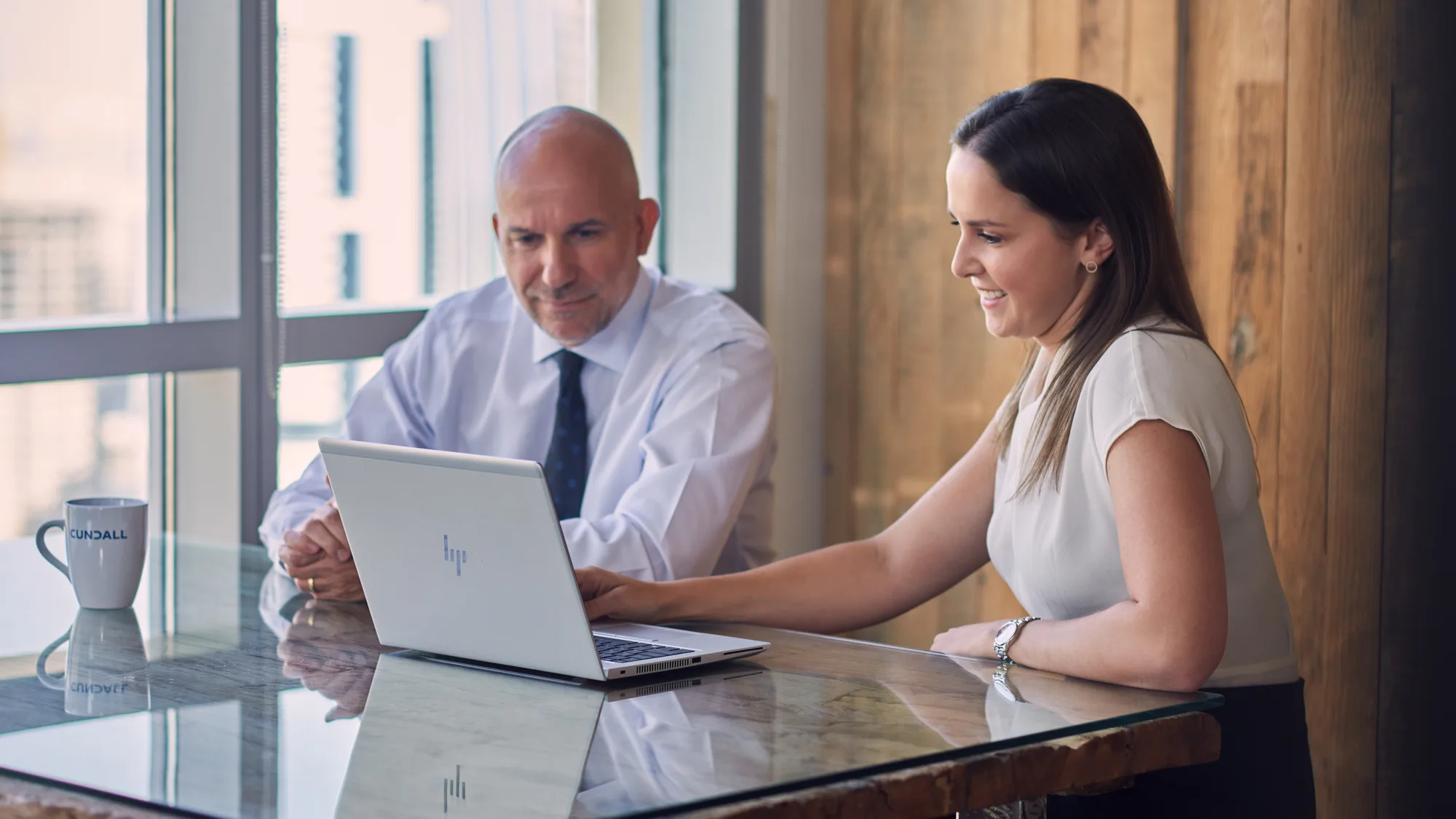 Annabelle Morris in meeting with colleague at a desk with laptop