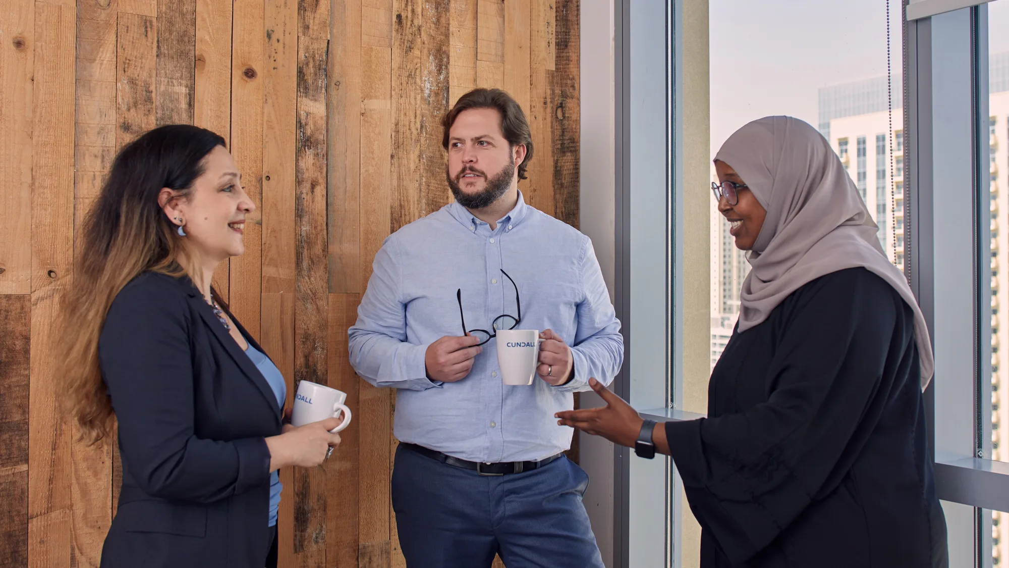 Lee French in office meeting near a window