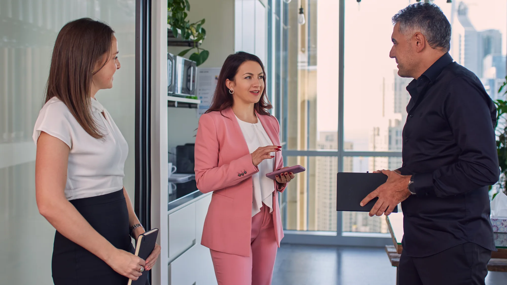 Olga Litkovets in standing meeting with windows in background