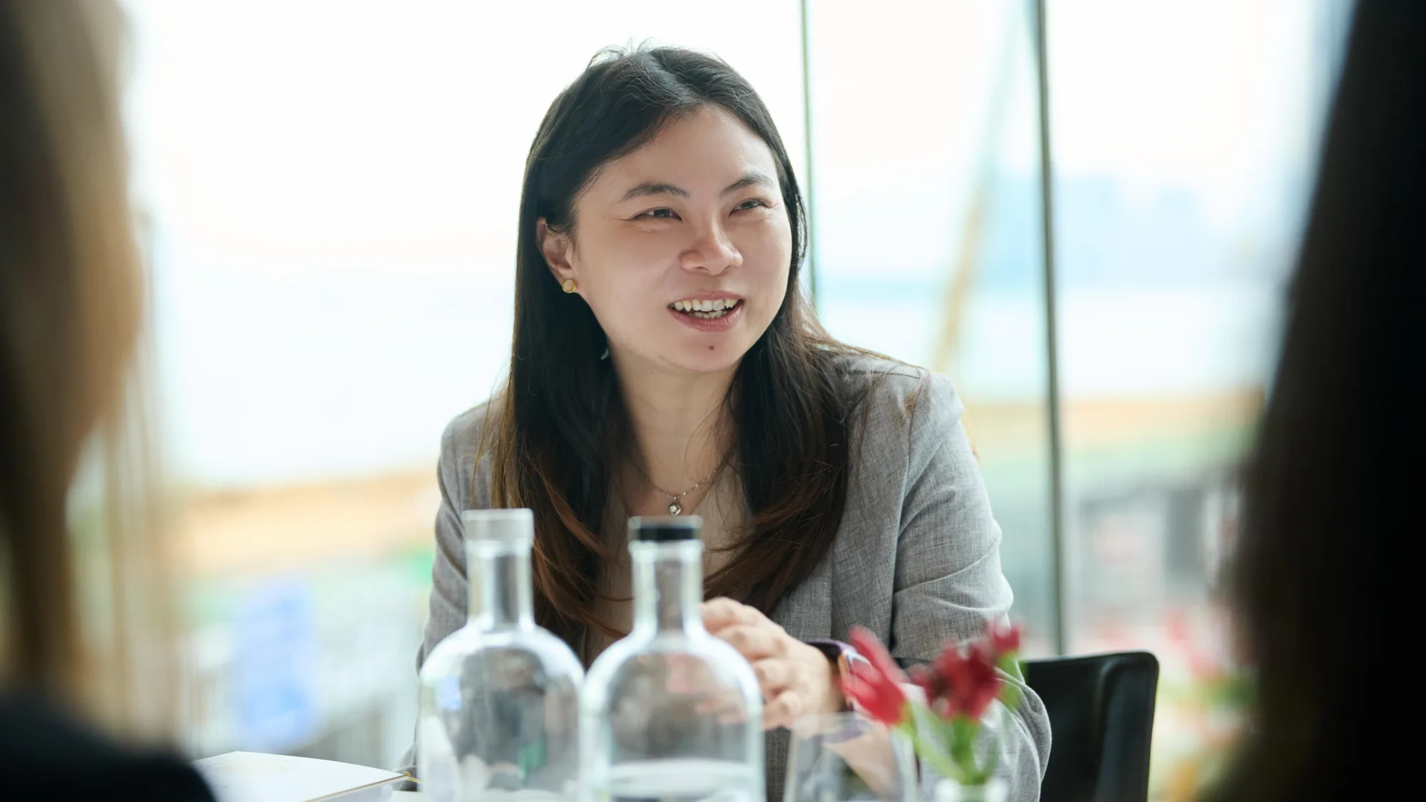 Ida Huang in grey jacket