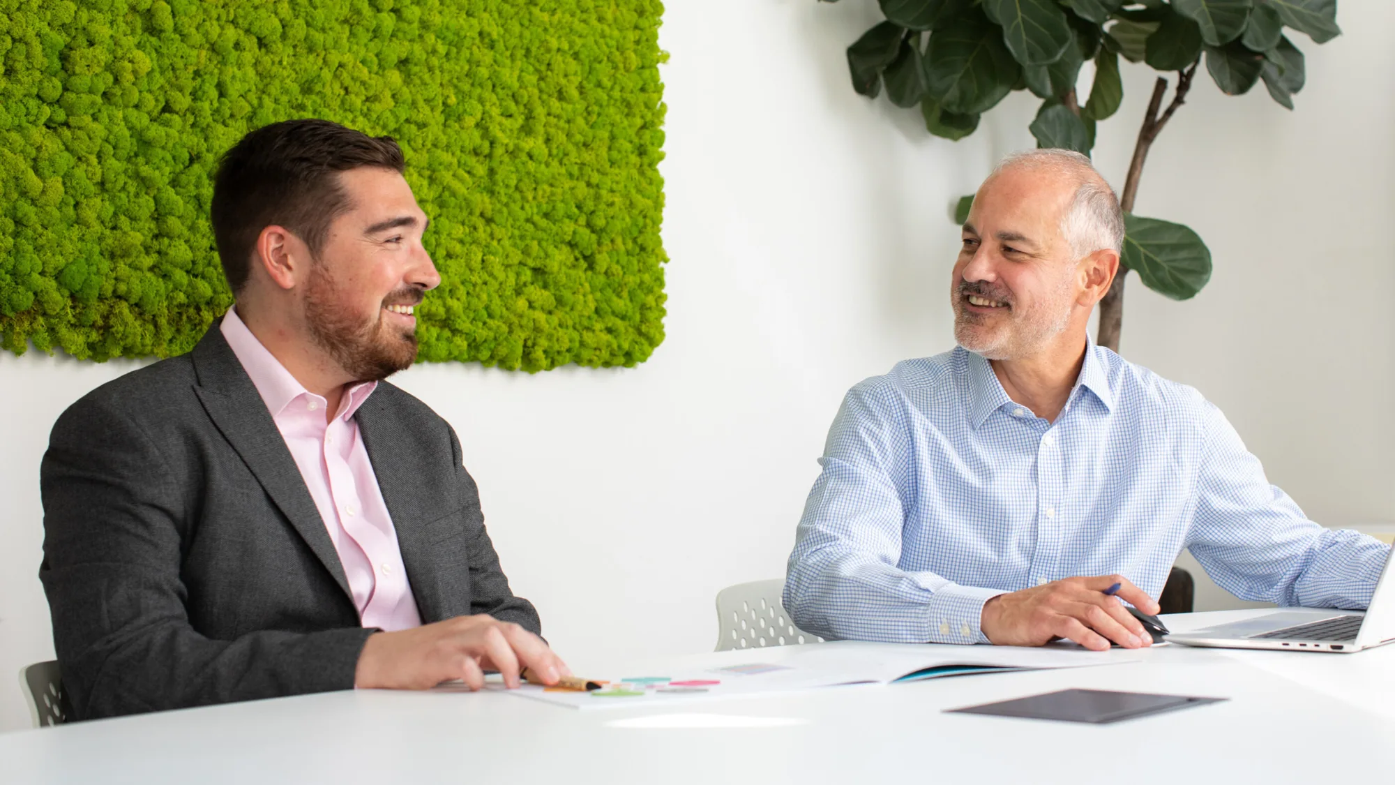 Gary Rollison in meeting with colleague looking at a laptop and sitting at a desk