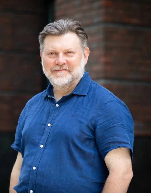 Malcolm Howe in front of office building
