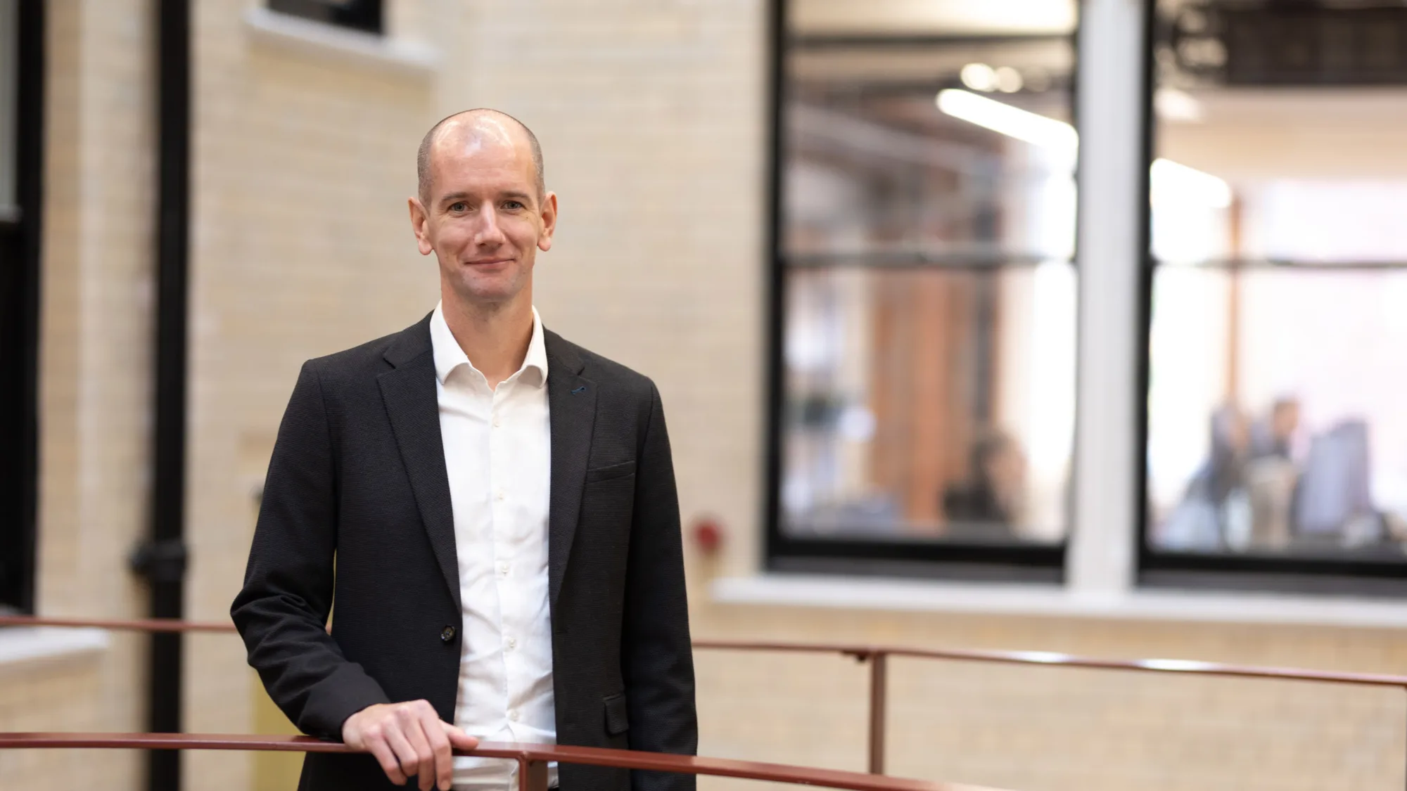 Rob Turner in foyer with red hand rail