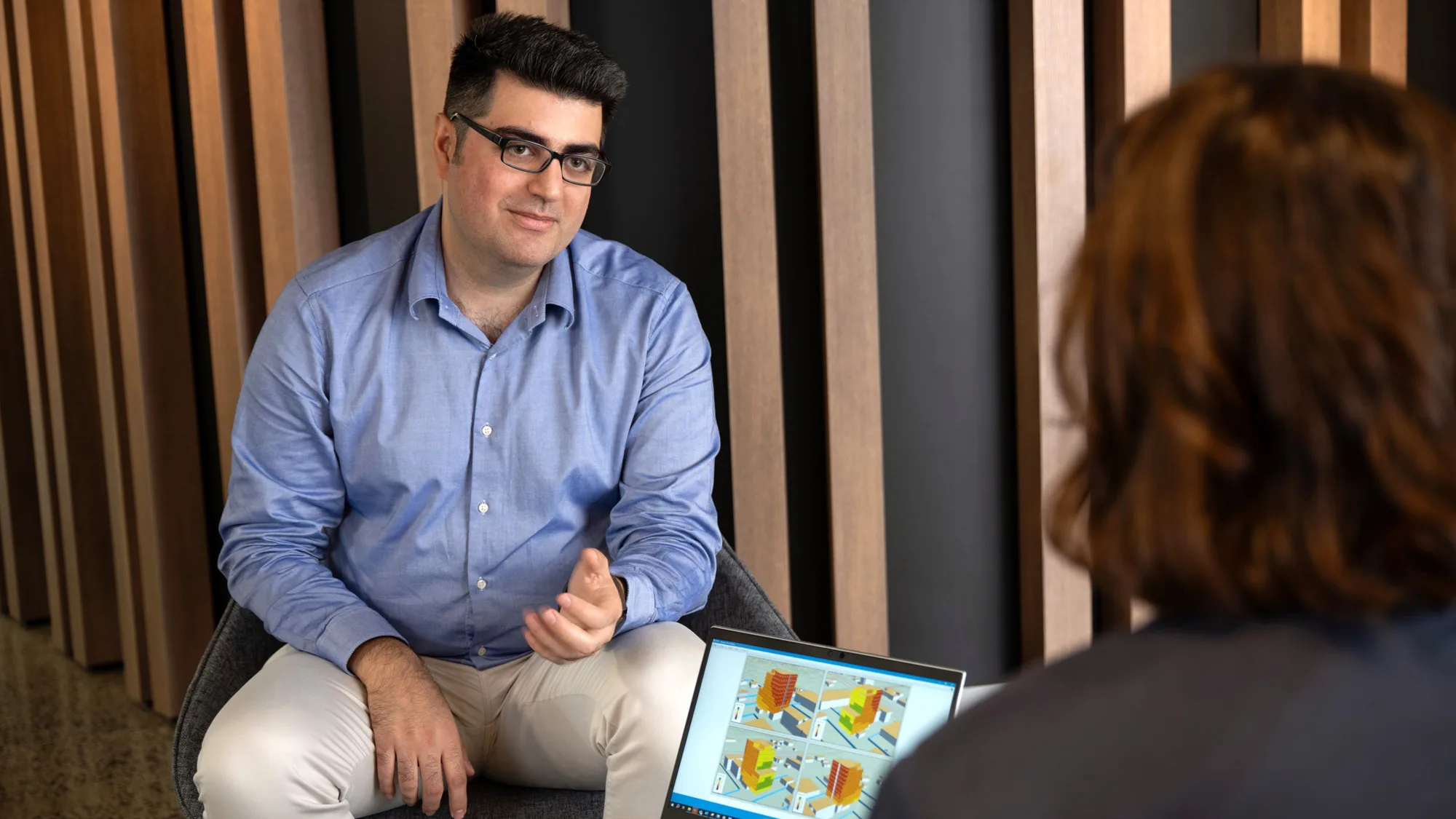 Vahid smiling and talking to an unknown person from across the table