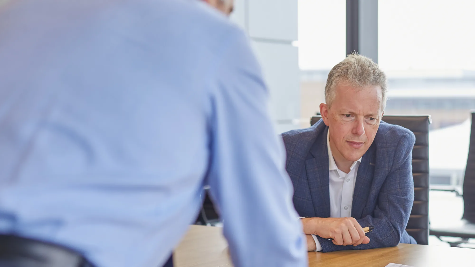 Duncan Cox sat at a desk