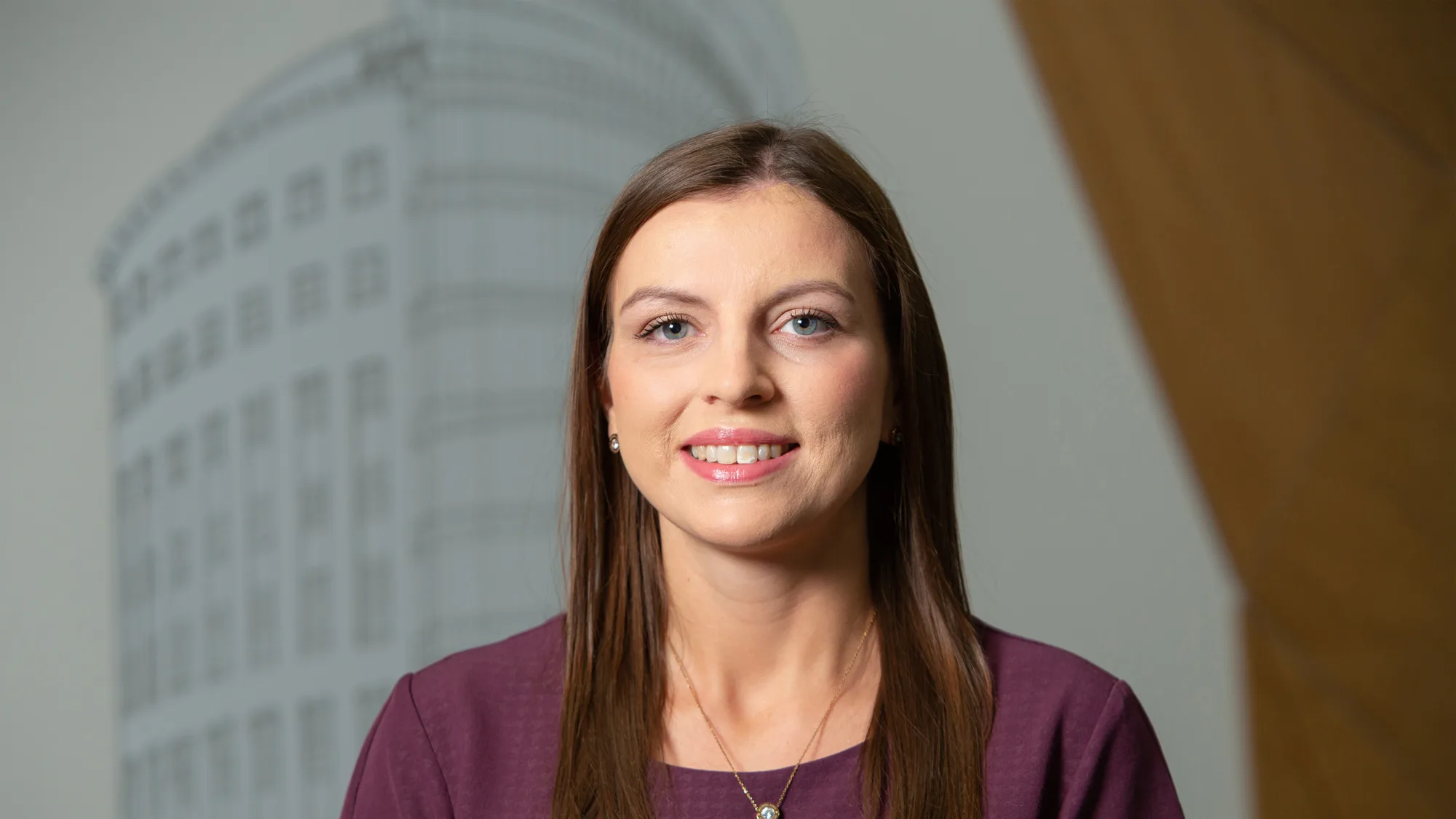 Head and shoulders shot of Rachel wearing burgundy top