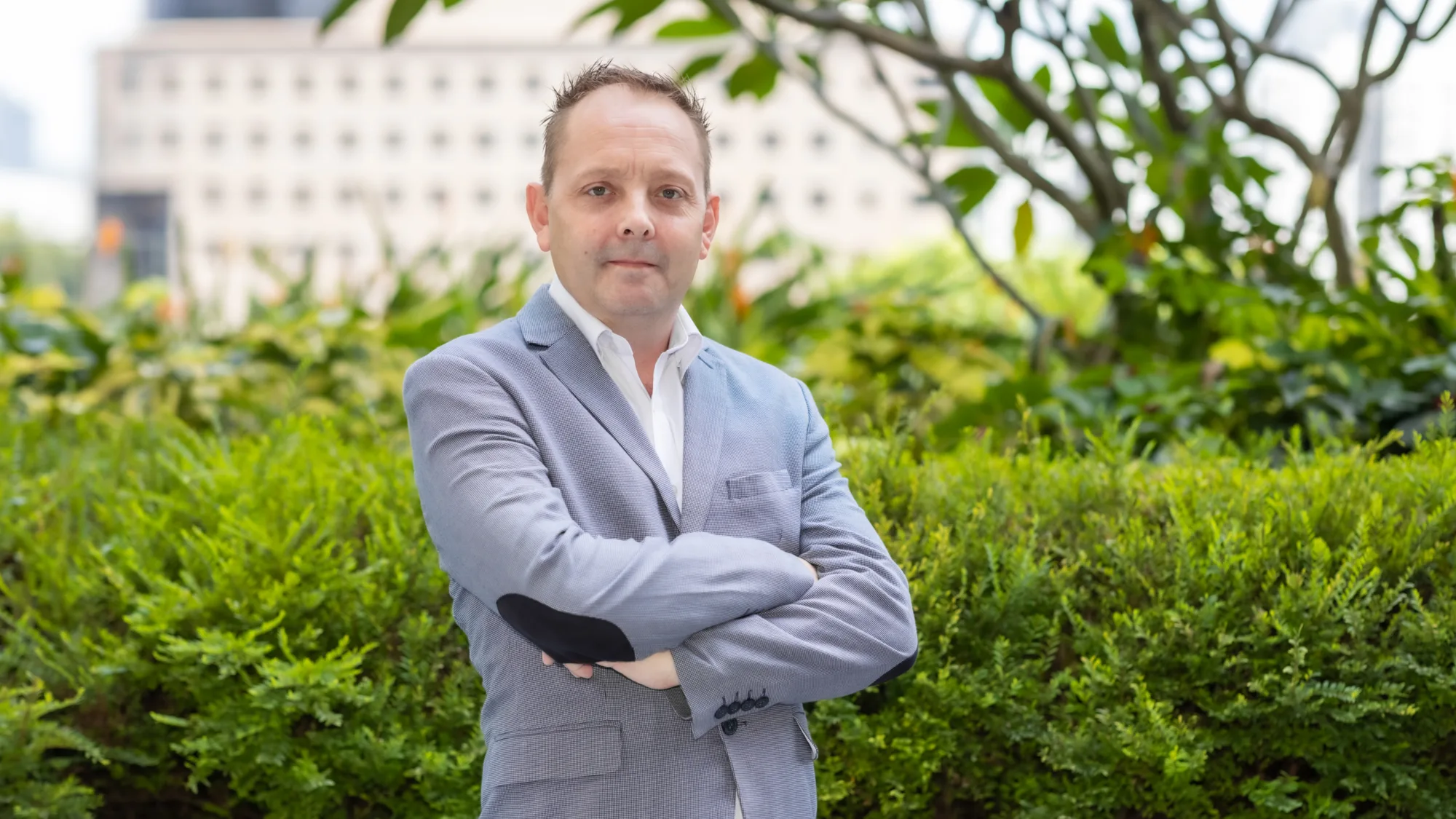 Matt Marshall with plants and building in background
