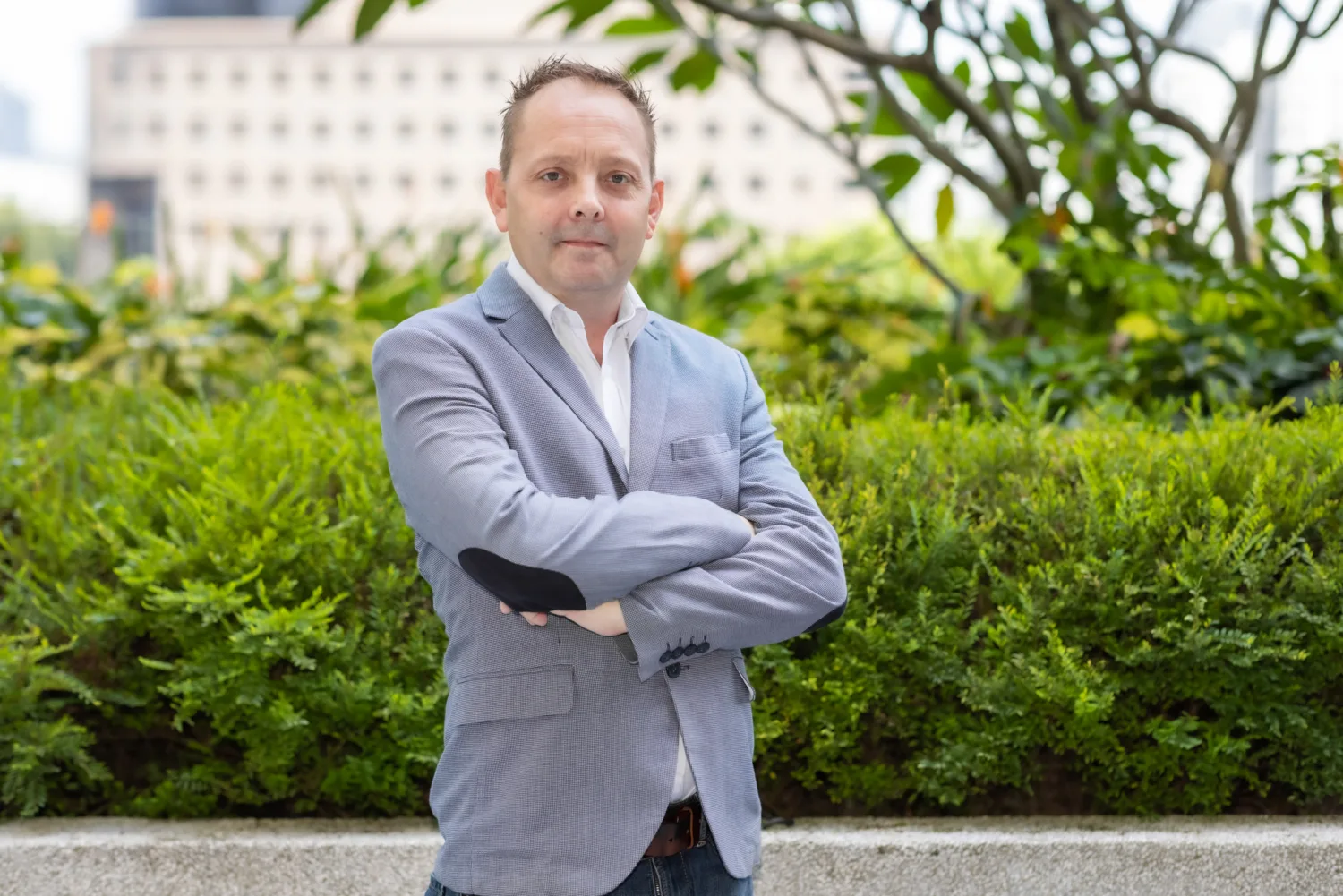Matt Marshall with plants and building in background