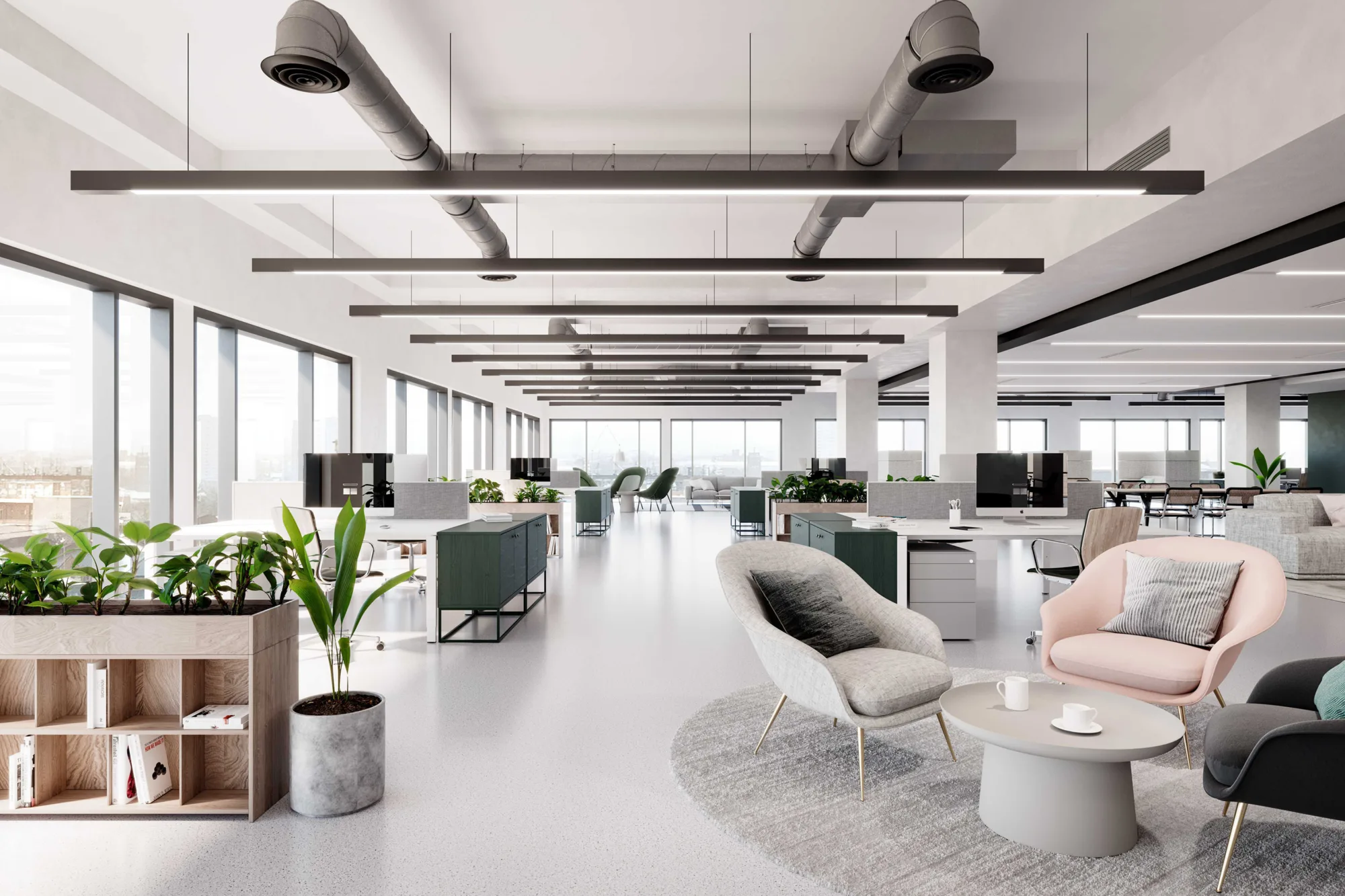 Bright, modern office space, with communal seating areas, plants and large desk spaces.