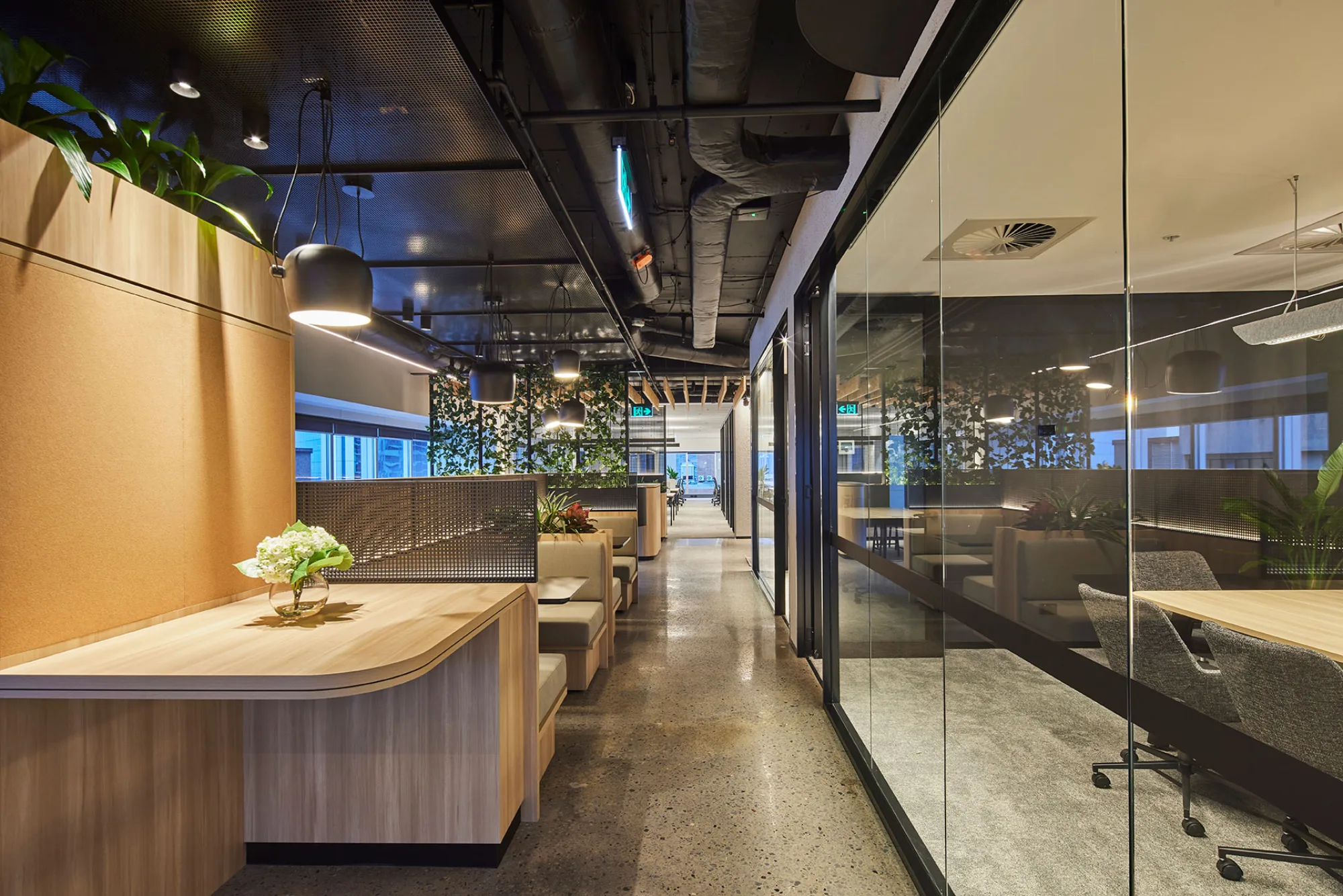 Corridor within office space including breakout collaboration space and meeting room