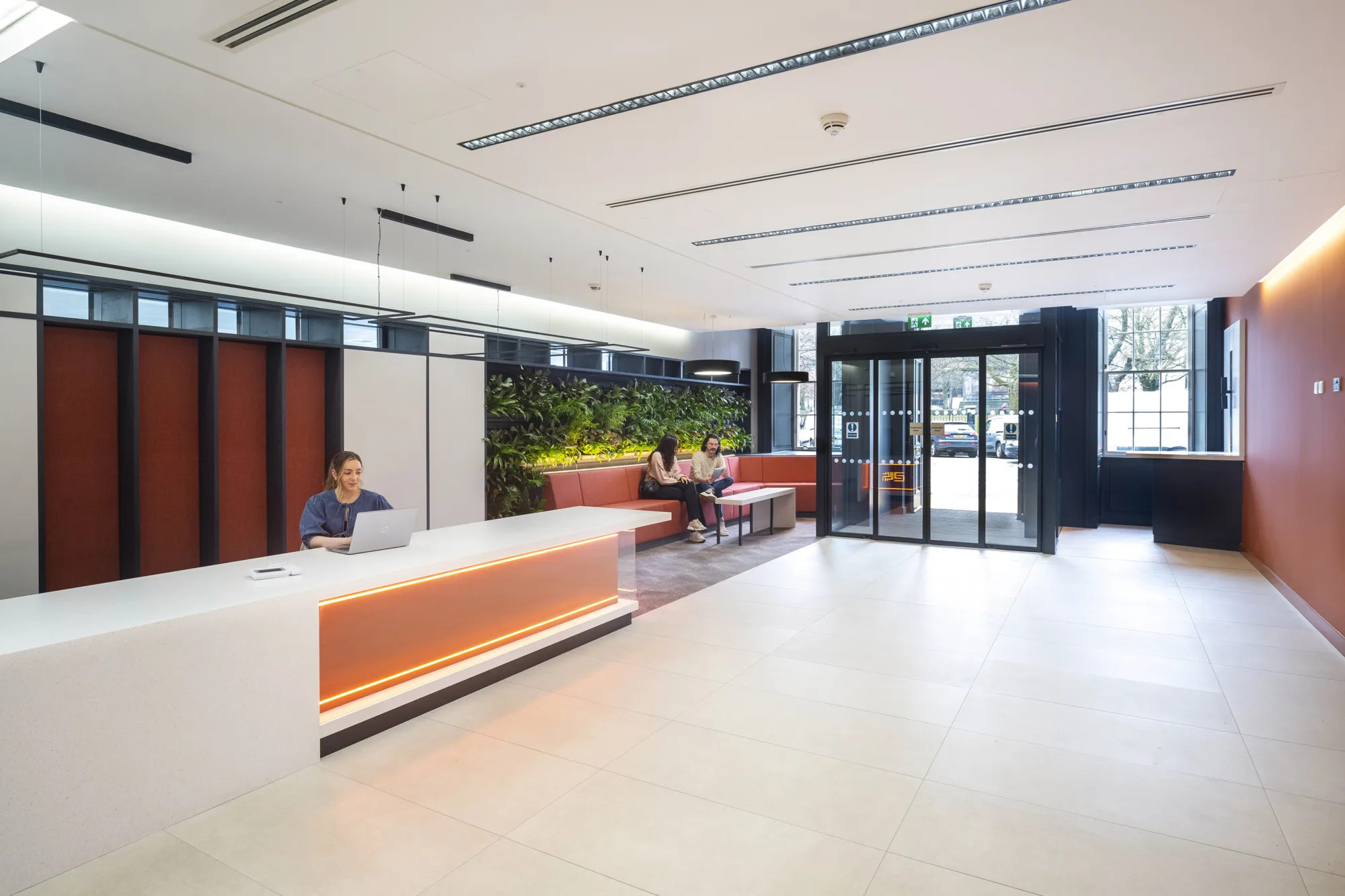Lobby and entrance area featuring a reception desk and a guest waiting area with seating.