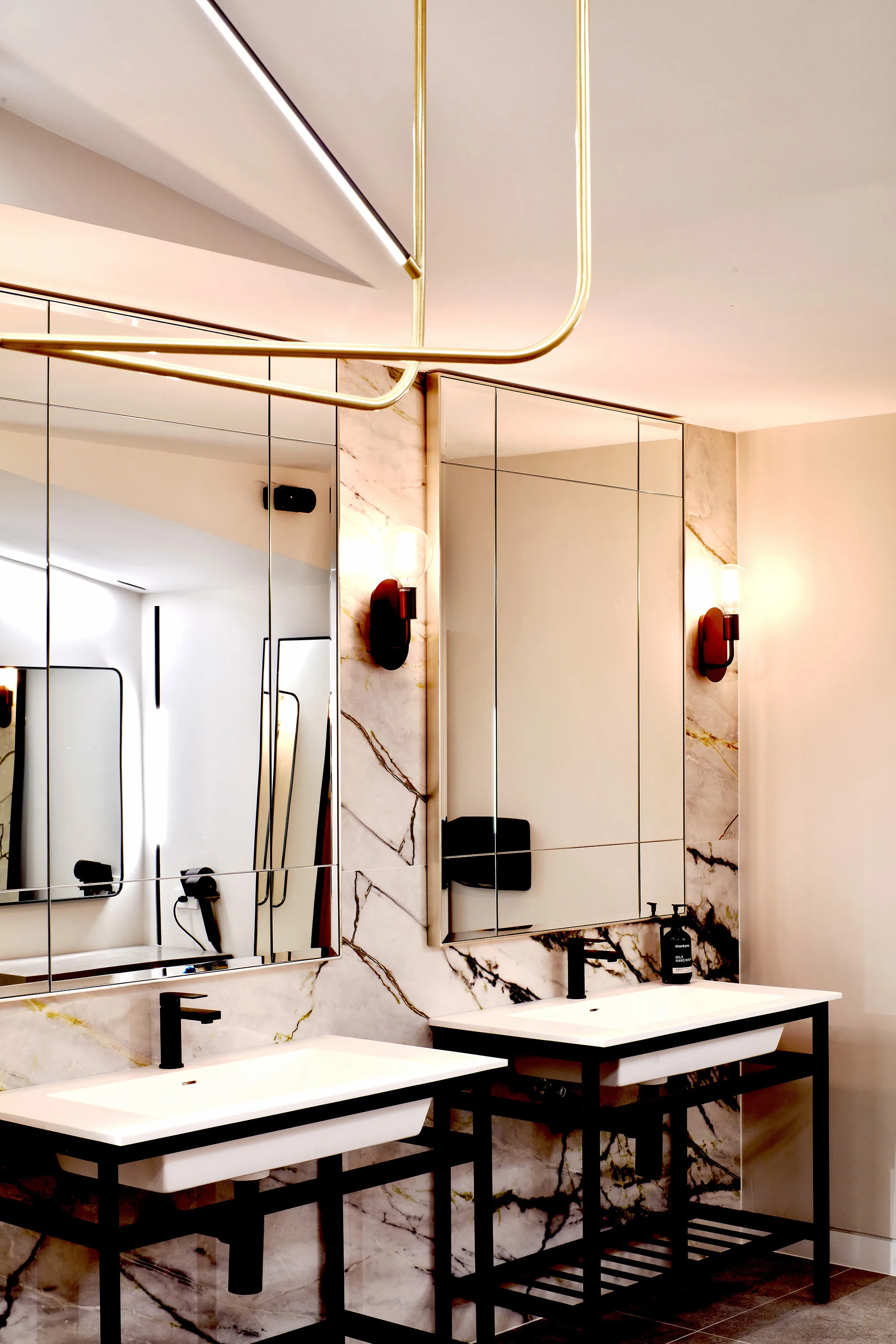 2 sinks below illuminated mirrors