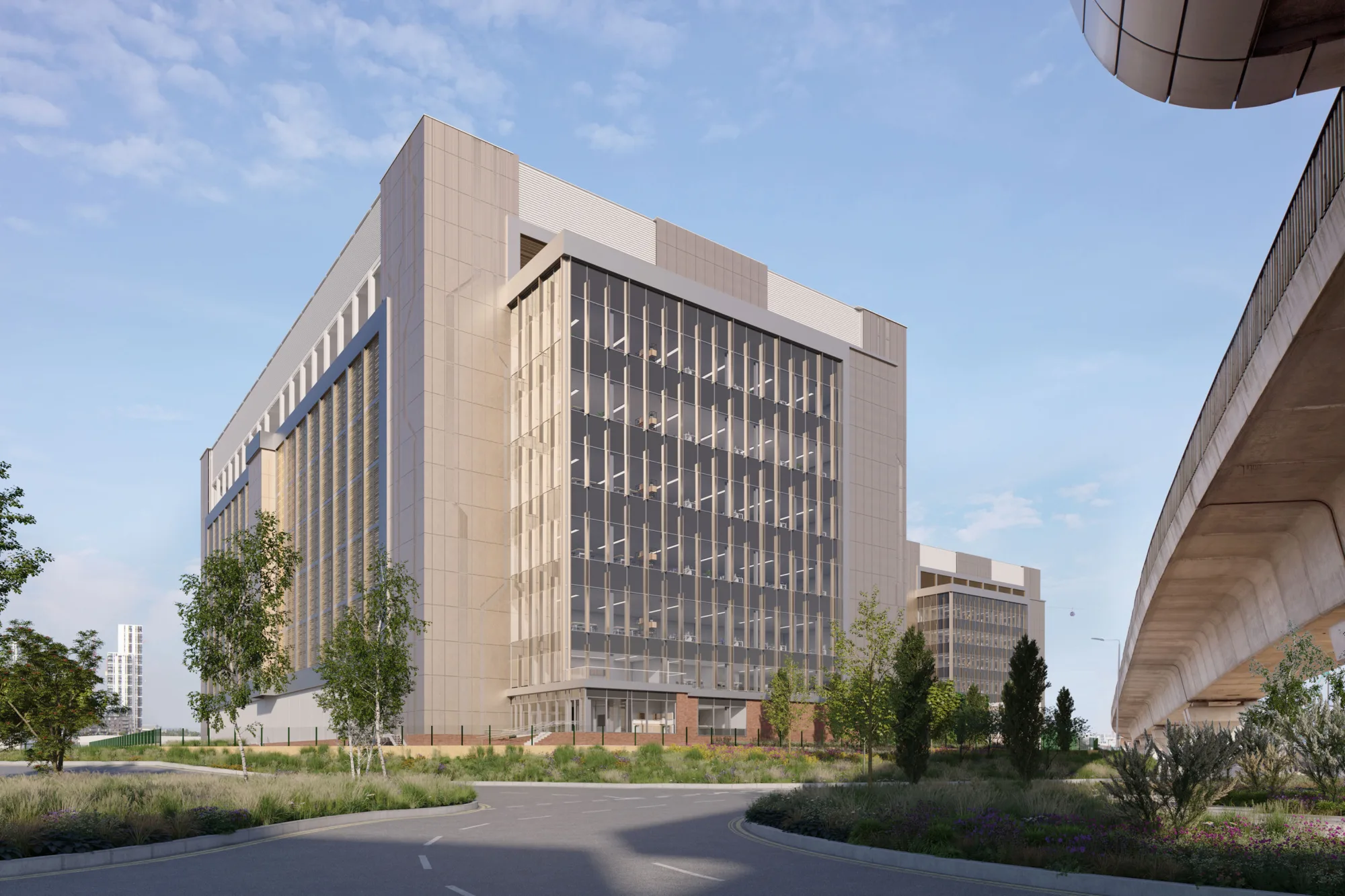 Daytime street view of Ada Infrastructures Docklands Data Centre with railway overpass on the right