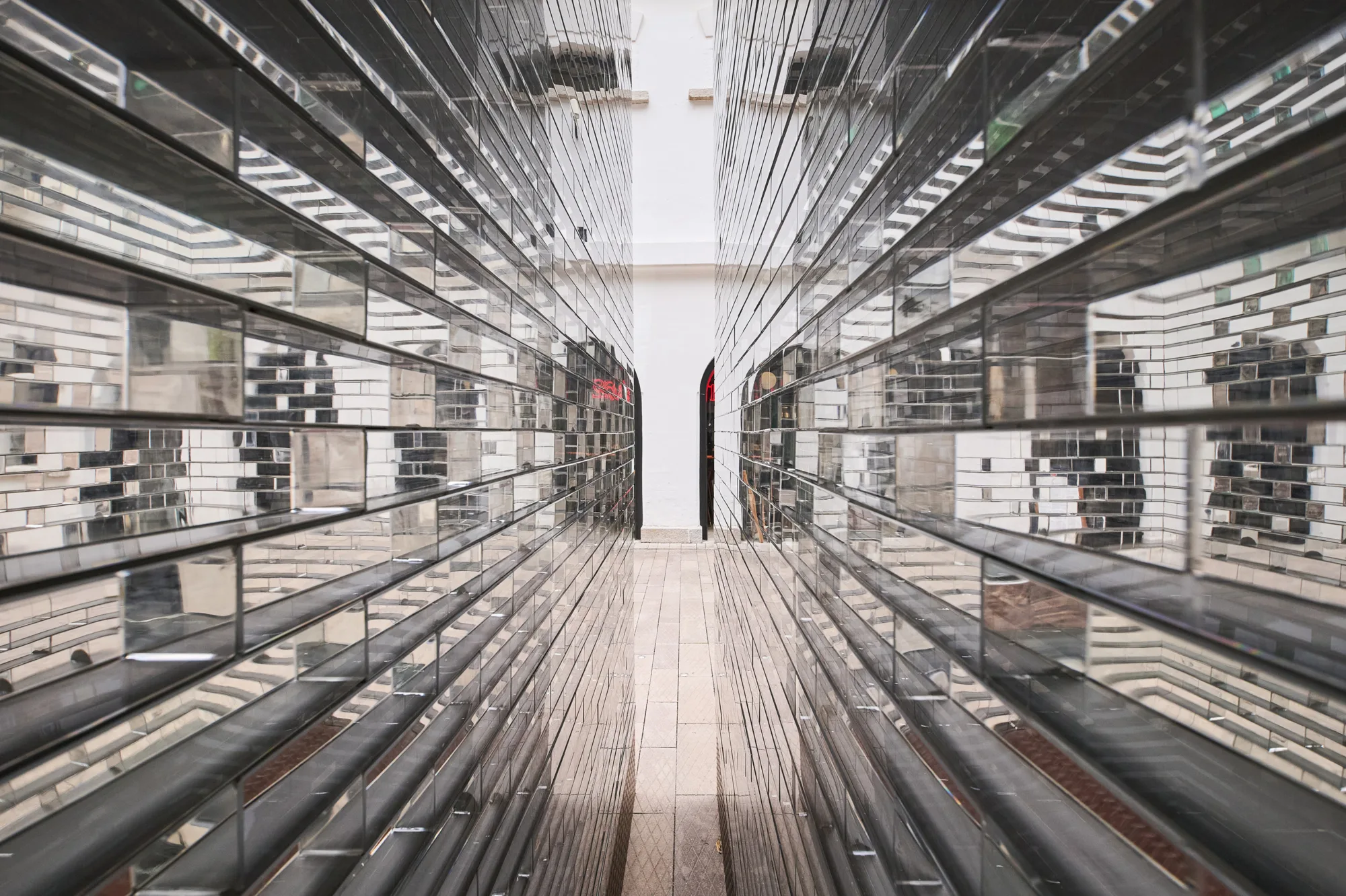 Perspective close up angle of glass sculpture installation by artist Alicja Kwade