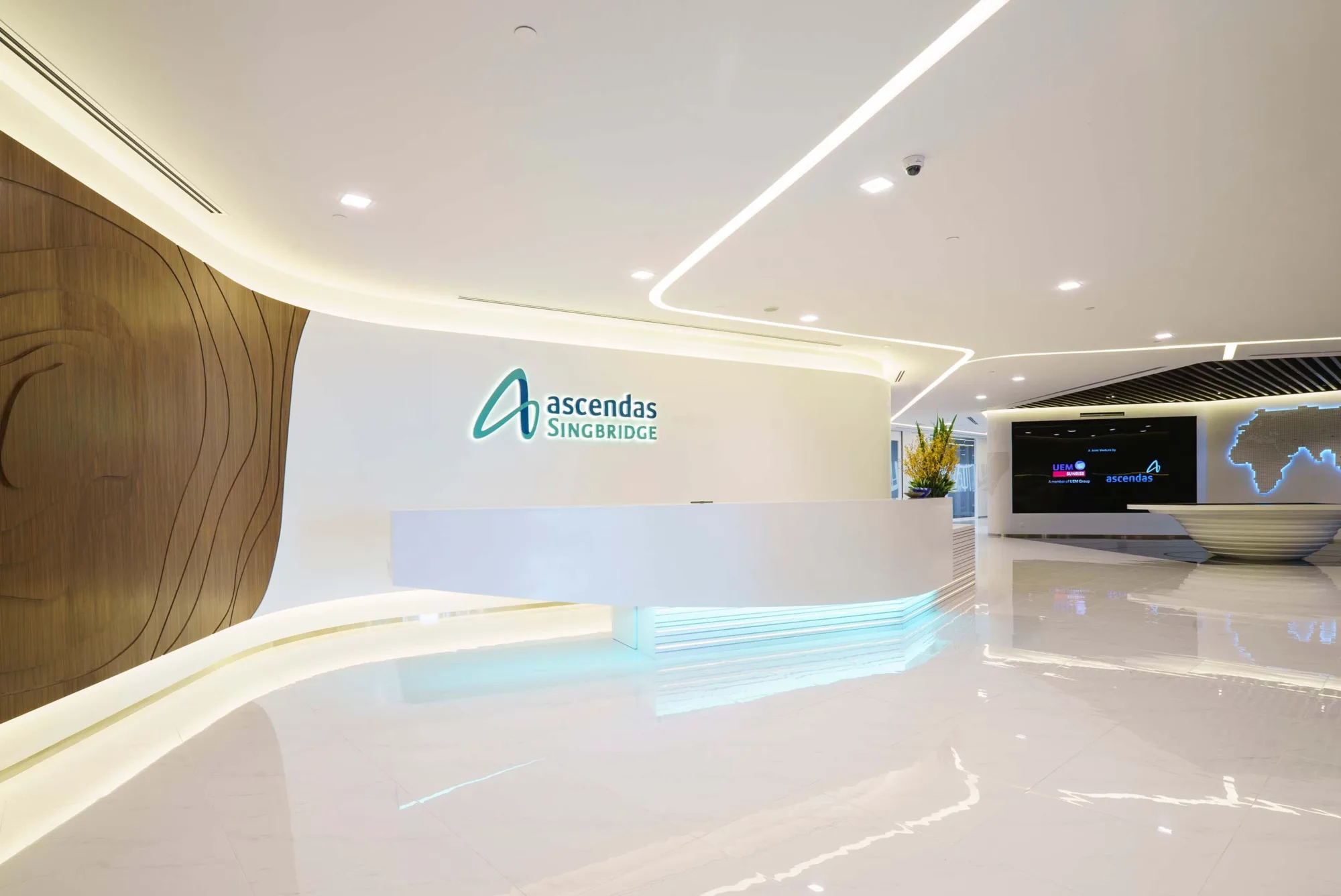 Bright and spacious marble-floored area featuring reception counter with Ascendas Singbridge logo behind it