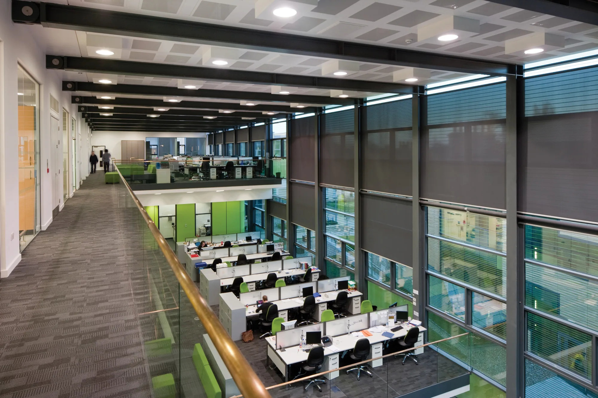 Banks of desks, viewed from an above mezzanine level