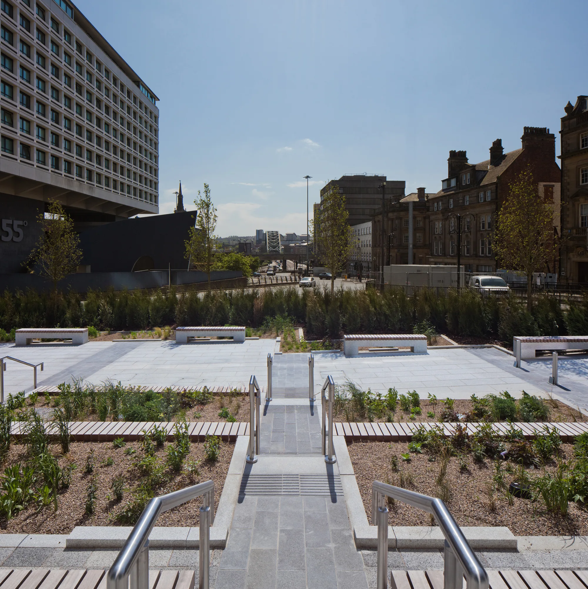 Looking from entrance of building into gardens and on to the city with a bridge in distance