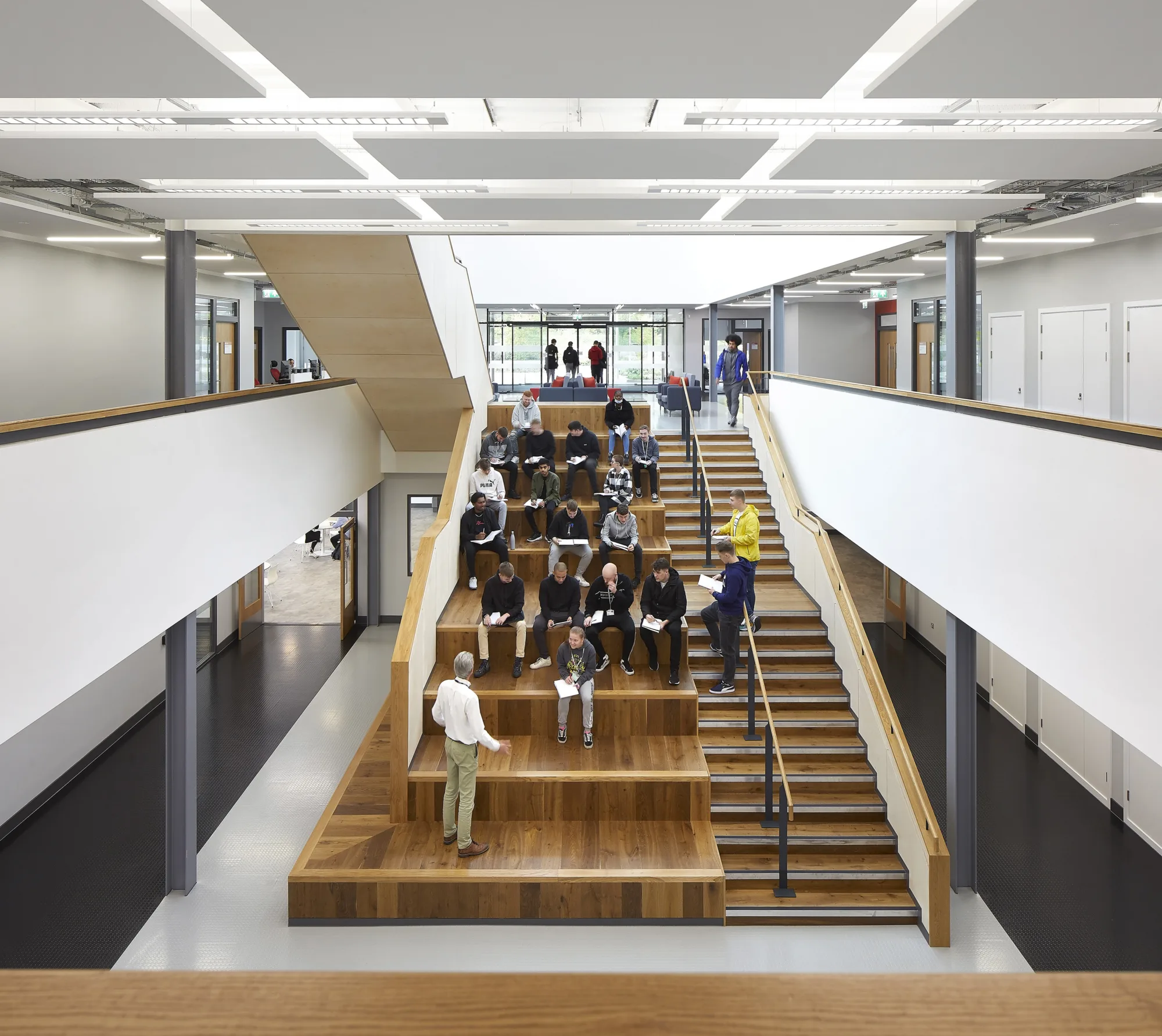 Central staircase with students sat on tiered seating