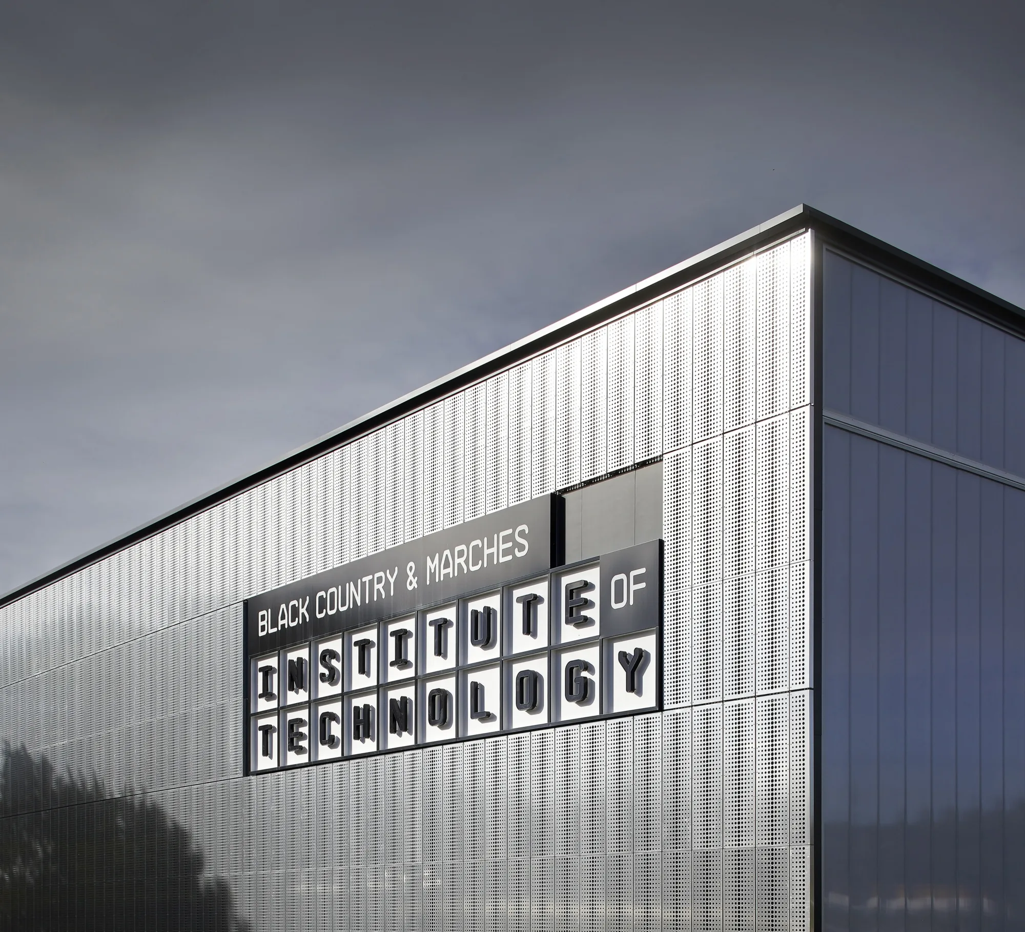 Metalic outside of the building showing the signage