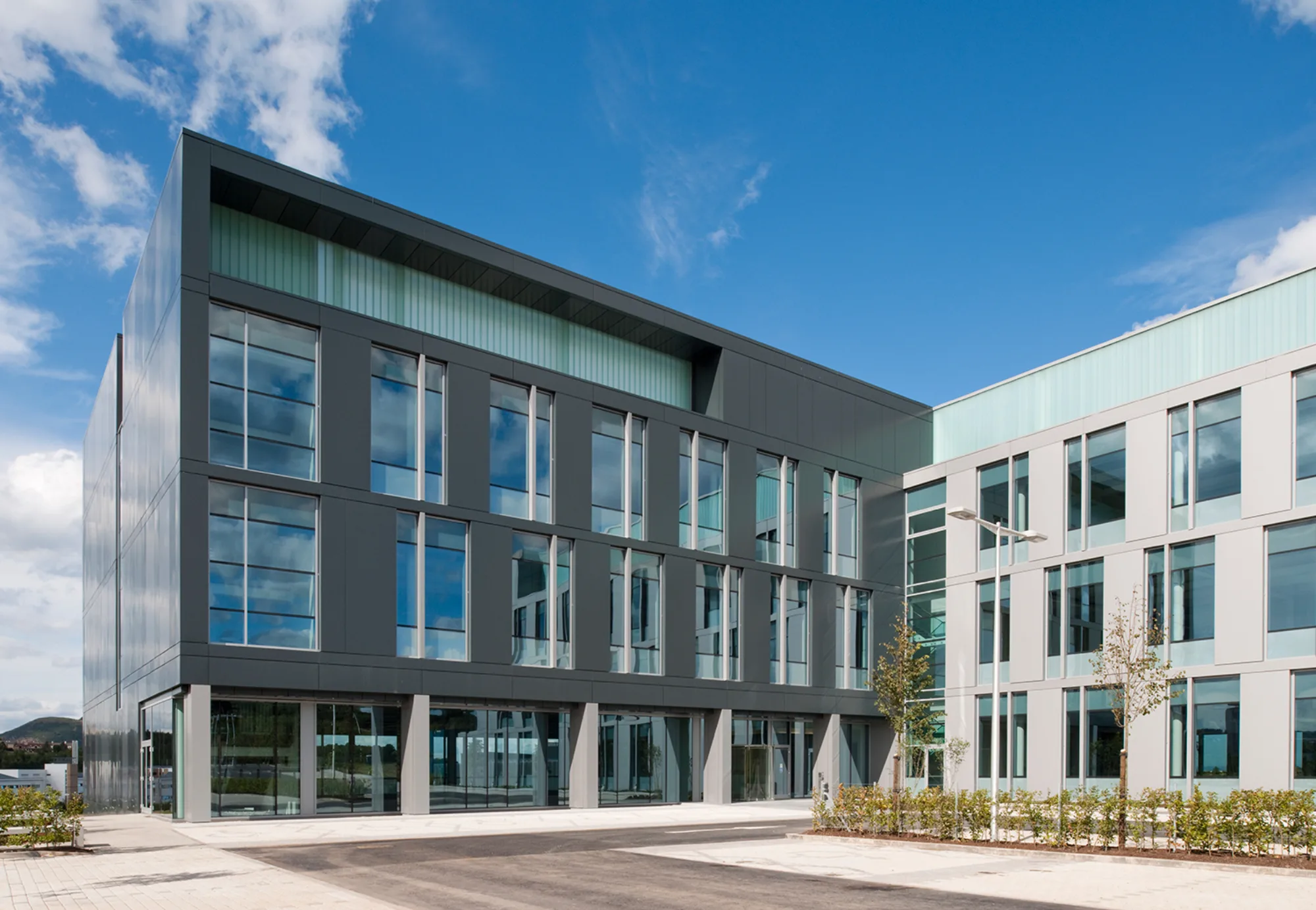 Edinburgh Bioquarter building with cladding and glass façade on a blue sky day