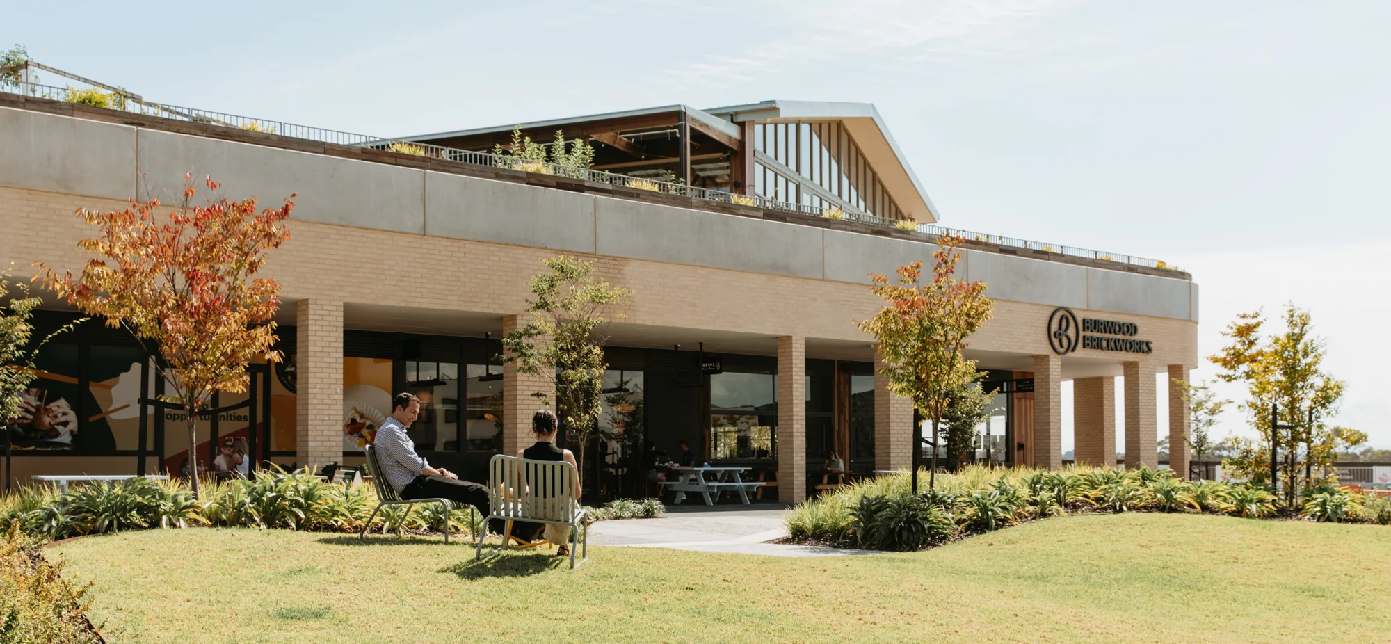Exterior view of lawns, deck chairs and Burwood Brickworks complex.
