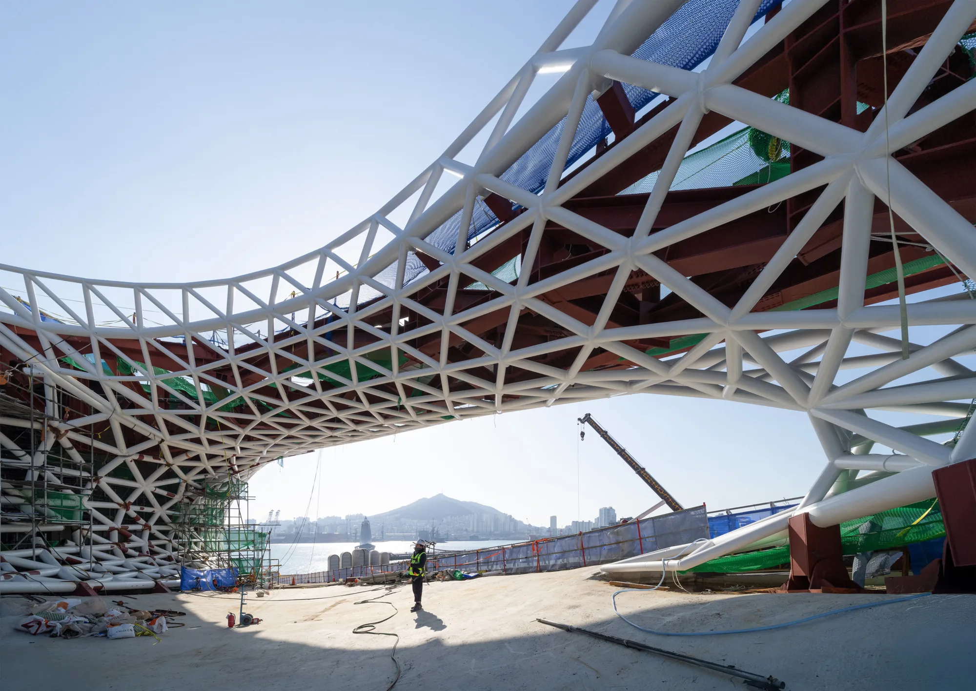 Construction progress photo of the Busan Opera House, highlighting the long span structures.