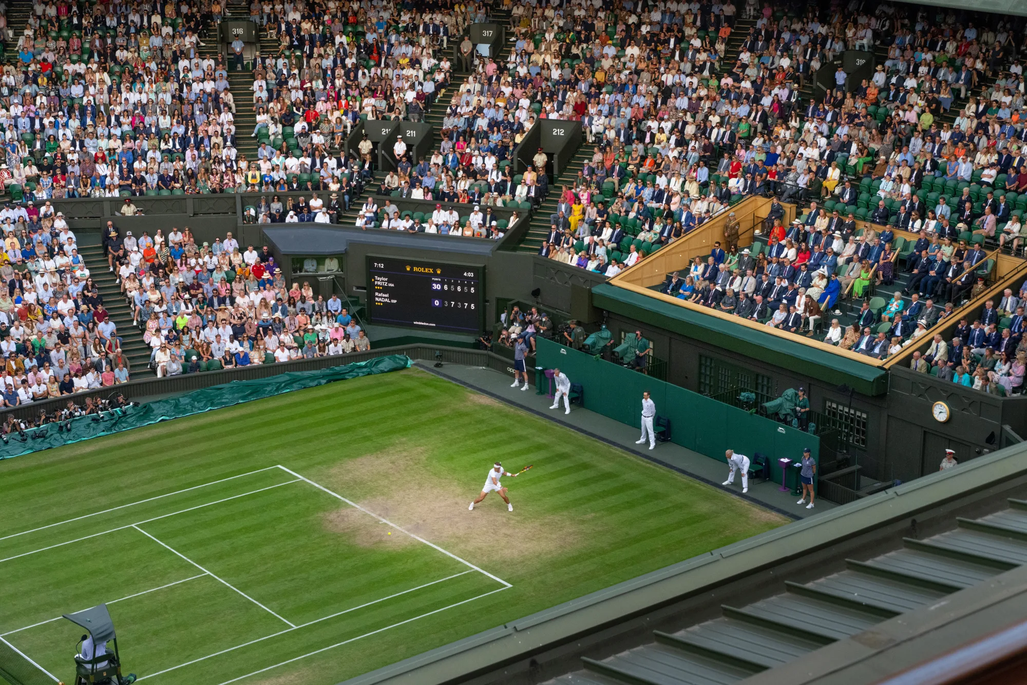 Aerial view of a player on centre court with a full crowd