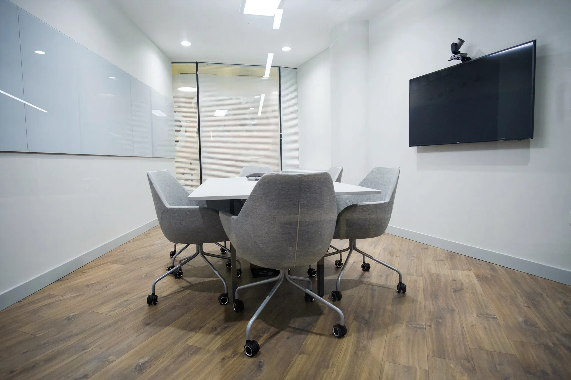 Cundall Qatar WELL office meeting room with wooden flooring, white board and tv