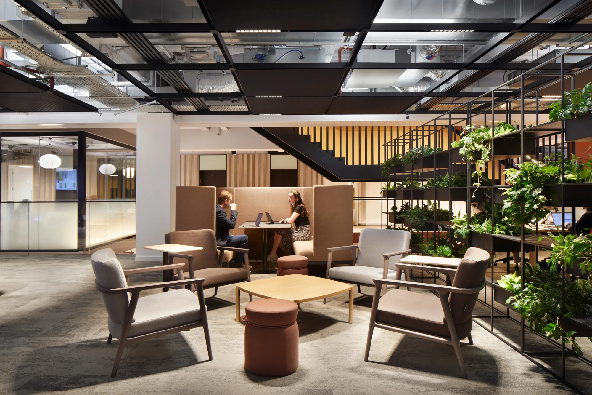 Seating area with a circular meeting booth being used by two people