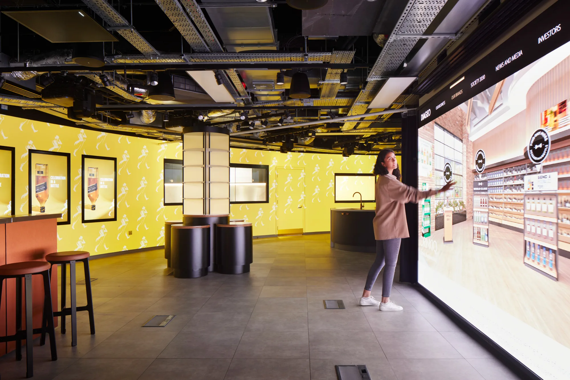 A person interacting with a digital wall in an event space