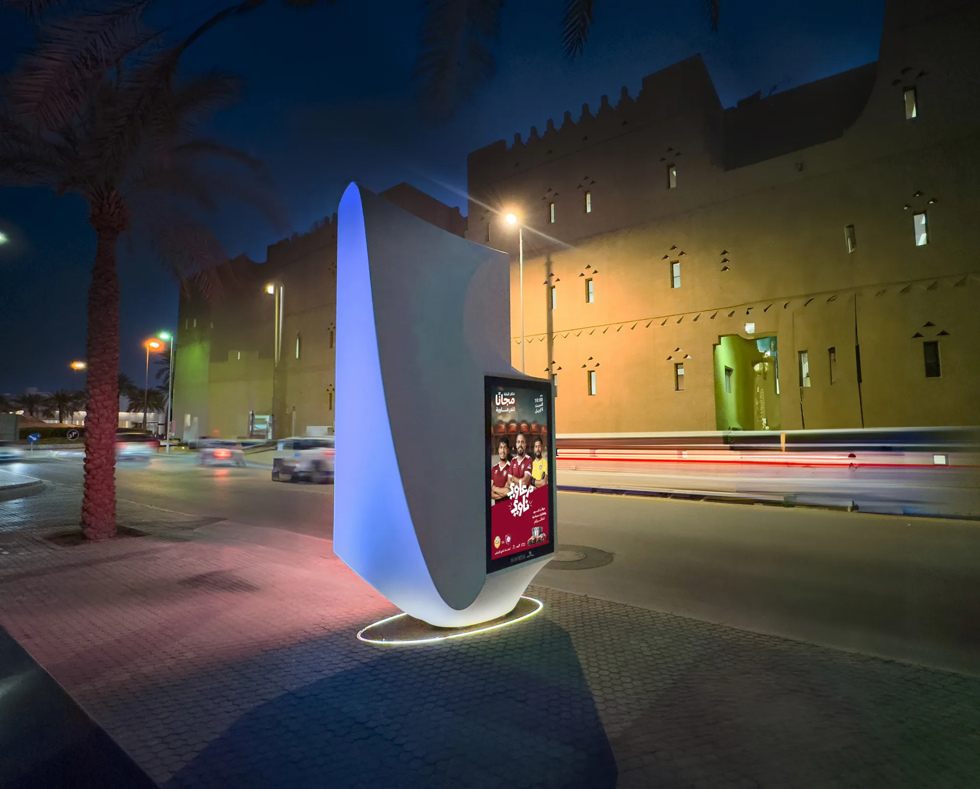The digital advertising sculpture photographed from an angle in front of a traditional building, showing the design and size of it